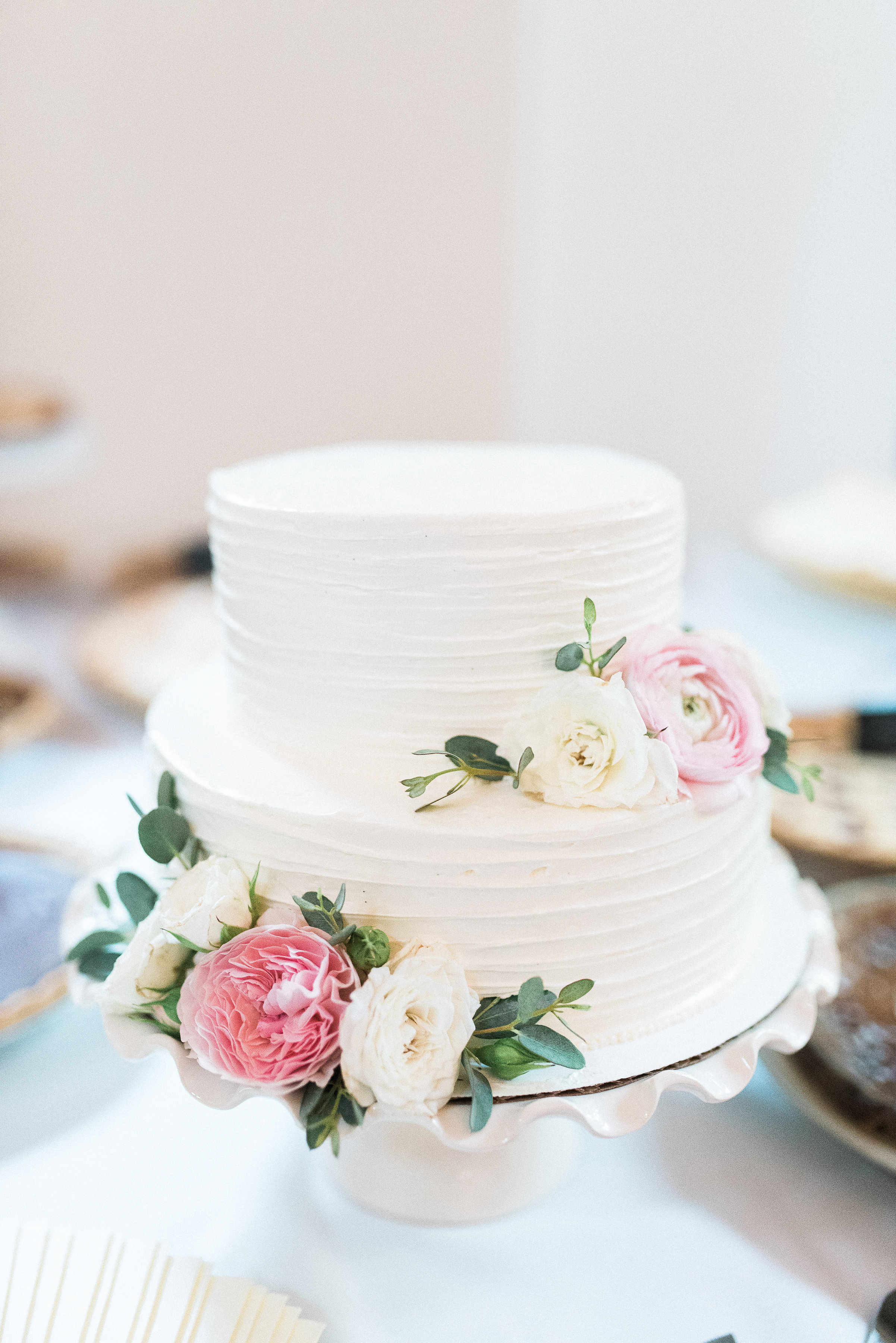 2 tier cake with soft pink and ivory floral accents // Nashville Wedding Florist