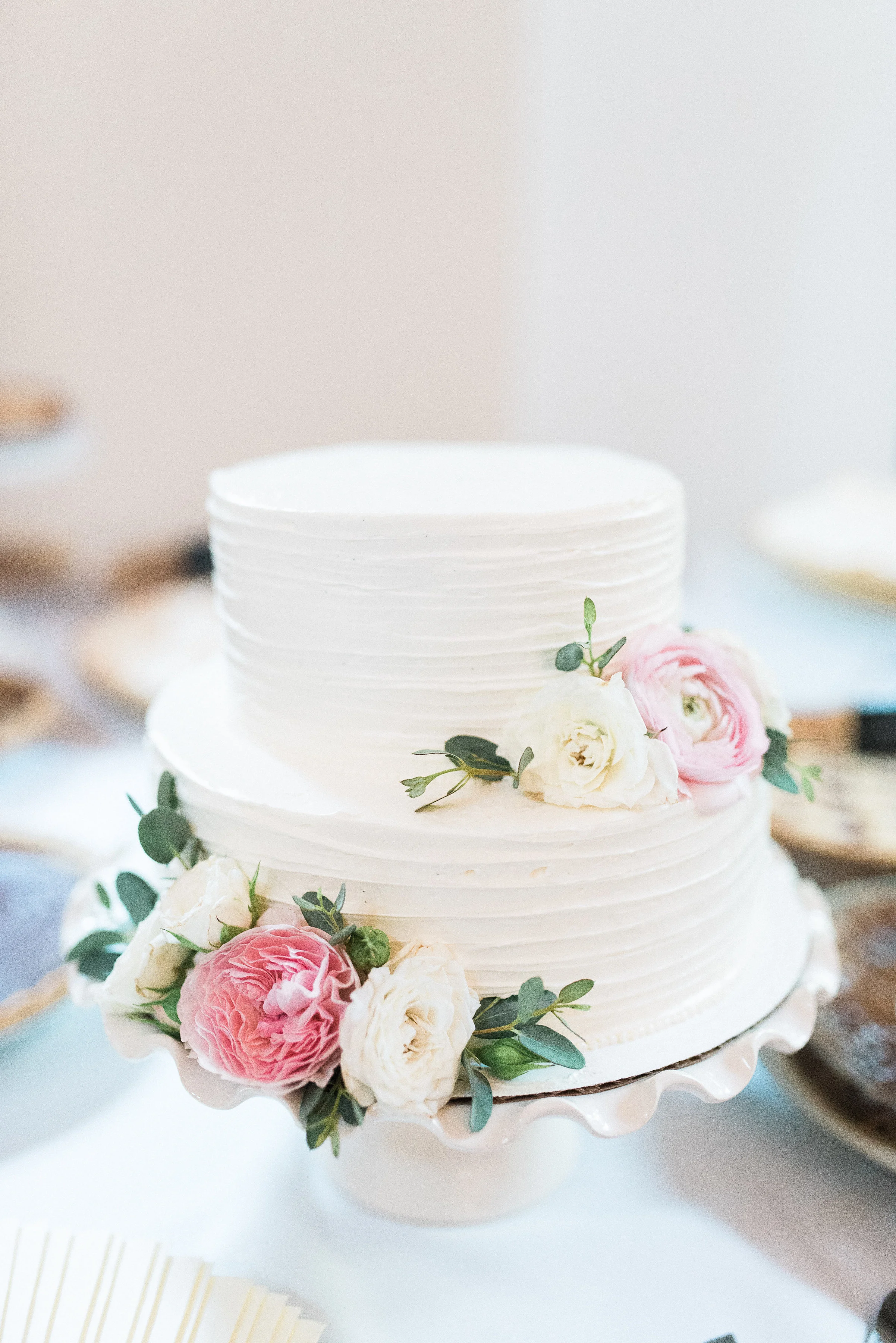 2 tier cake with soft pink and ivory floral accents // Nashville Wedding Florist