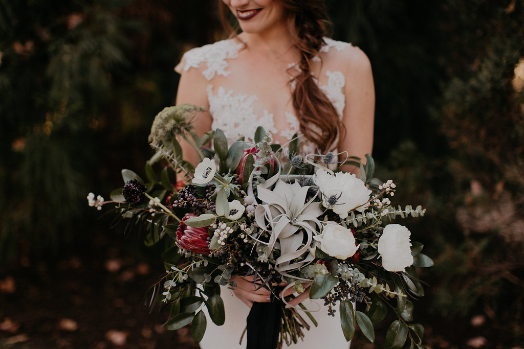 Wintry Bridal Bouquet with air plants, peonies, berries, eucalyptus, and loose, untamed greenery // Nashville Florist