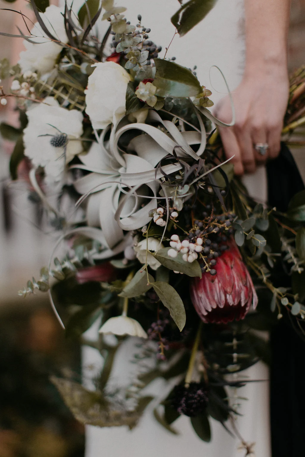 Wintry Bridal Bouquet with air plants, peonies, berries, eucalyptus, and loose, untamed greenery // Nashville Florist