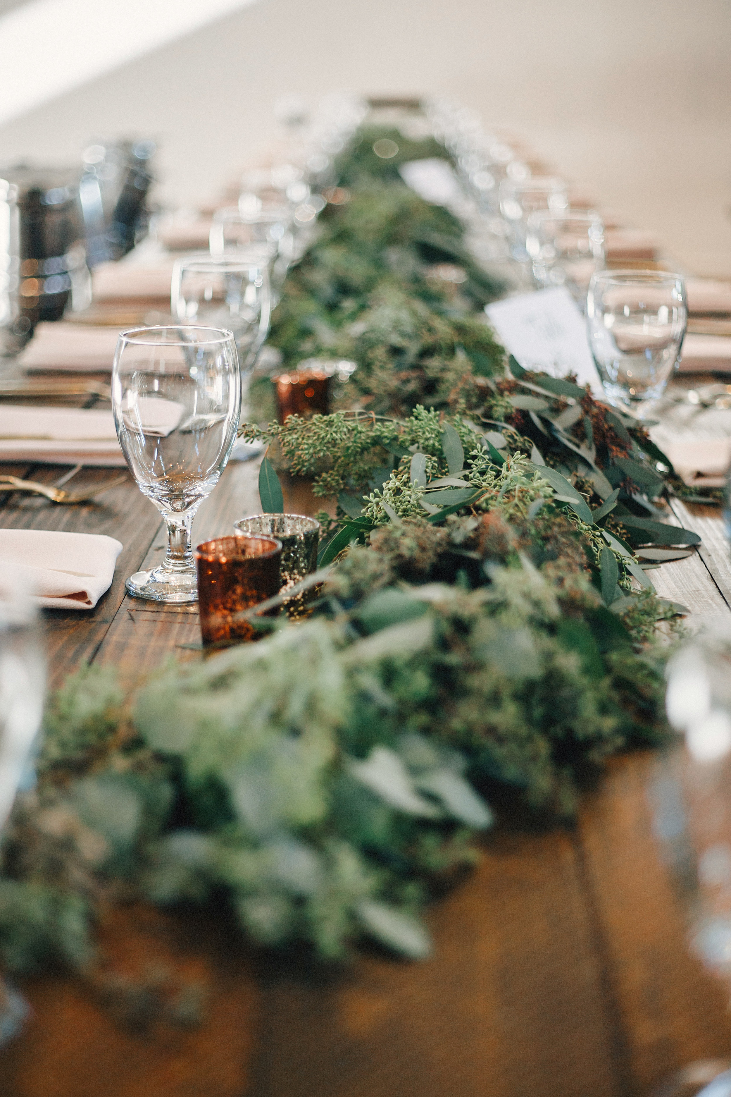 Lush greenery garland runner on farm tables // Nashville Wedding Floral Design