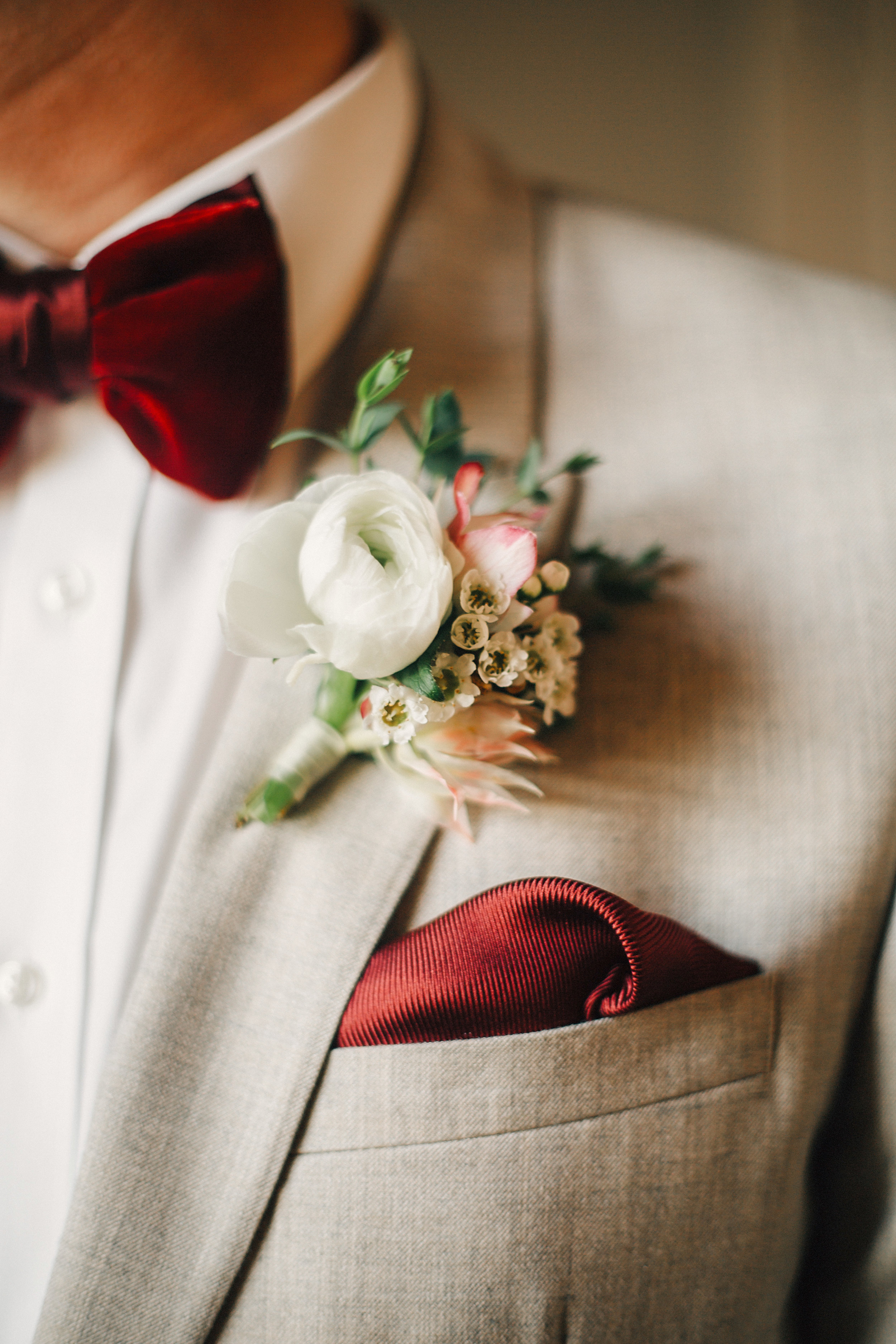 White Ranunculus Boutonniere and Red Velvet Bow Tie // Nashville Fall Wedding Florist