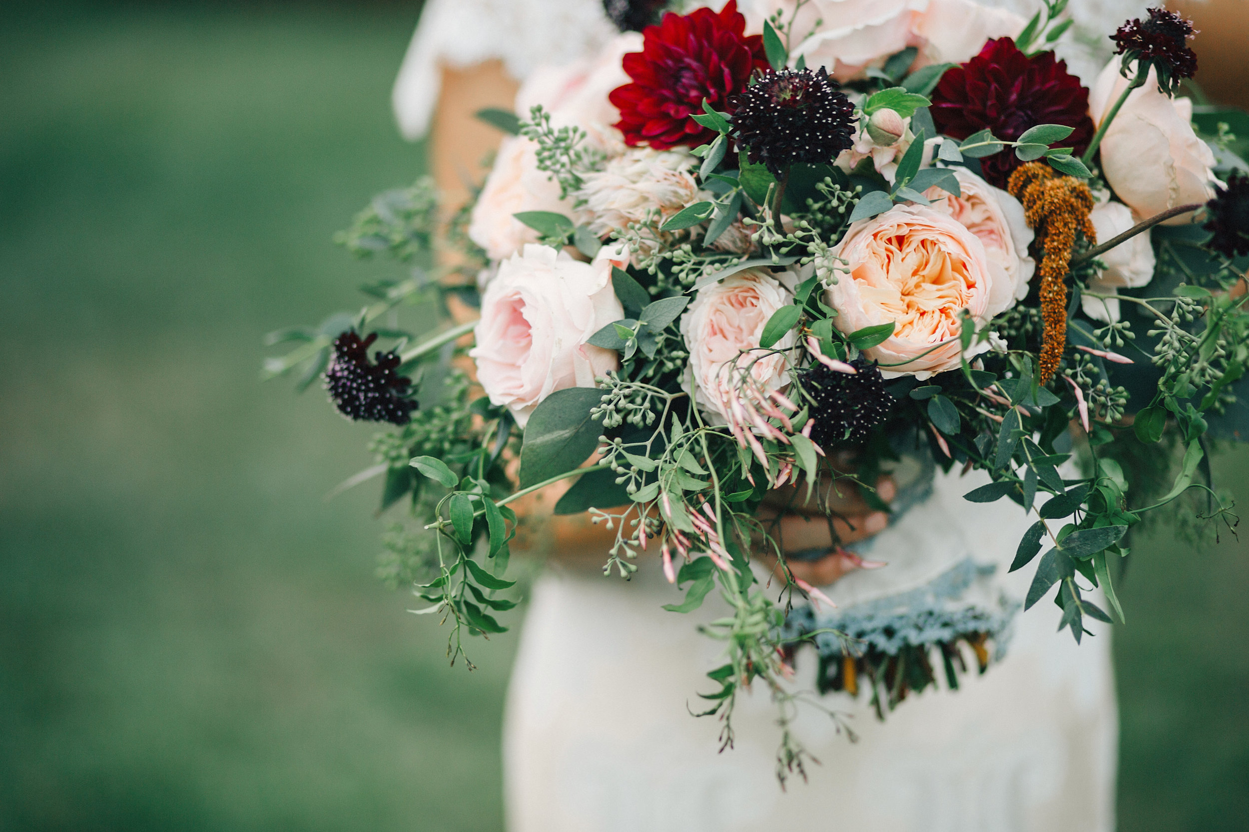 Lush, organic bridal bouquet with burgundy dahlias, peach garden roses, and trailing greenery // Nashville Wedding Floral Design