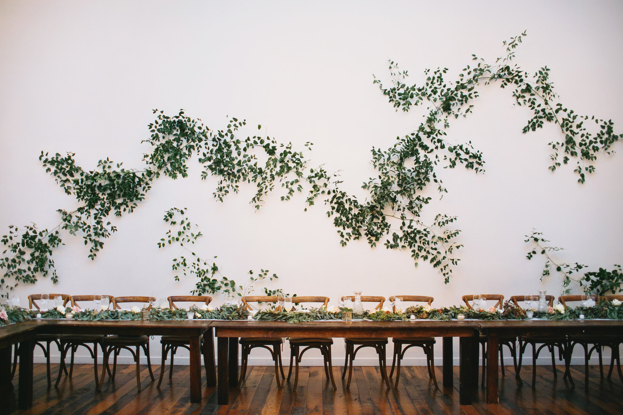 Large greenery vine installation on a white wall //Nashville Wedding Florist