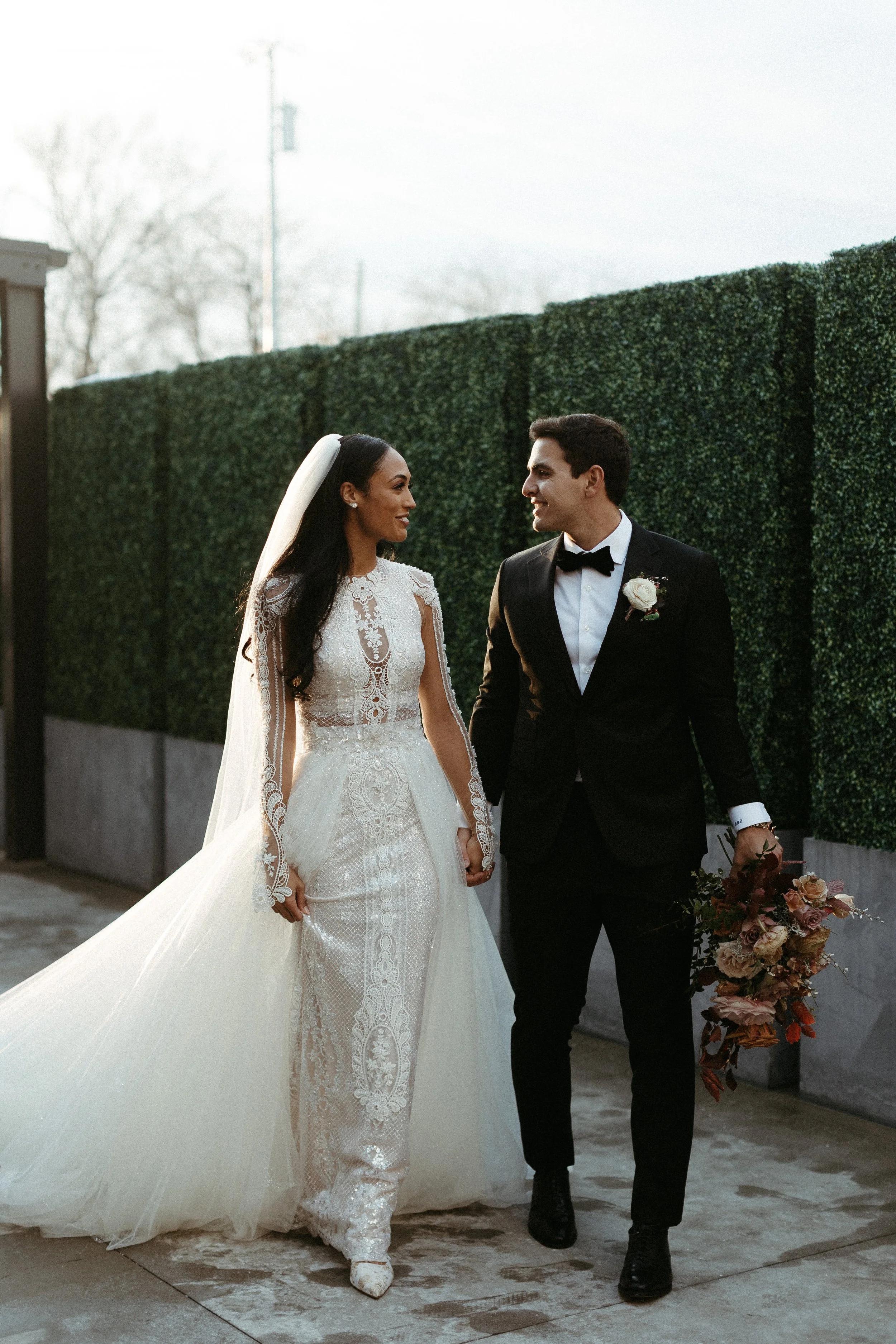 This elegant bridal bouquet brought hues of mauve, dusty pink, cream, burgundy, and terra cotta to this winter wedding. Lush with petal heavy roses, ranunculus, spray roses, copper beech, and greenery. Designed by Rosemary and Finch in Nashville, TN.