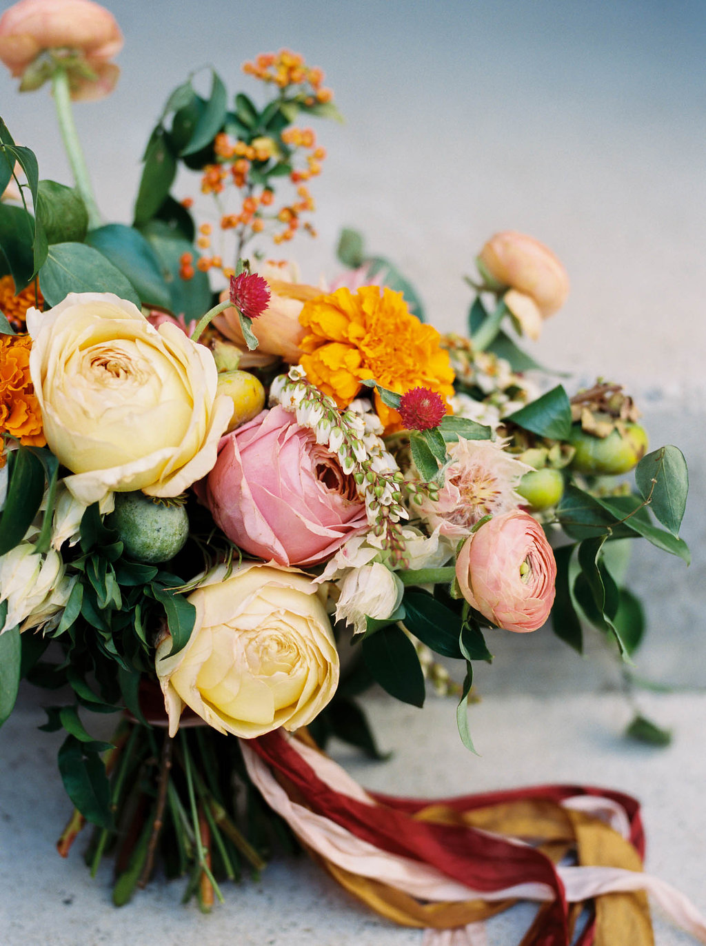 Bright, summery bridal bouquet with rosy pink garden roses and orange marigolds // Nashville Wedding Florist