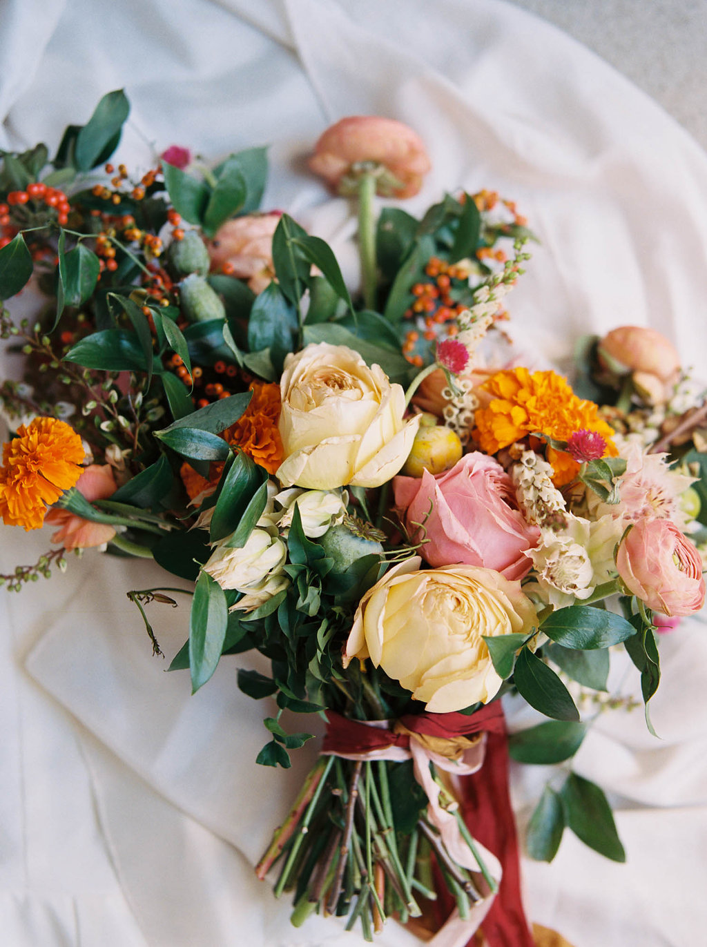 Bright, summery bridal bouquet with rosy pink garden roses and orange marigolds // Nashville Wedding Floral Design