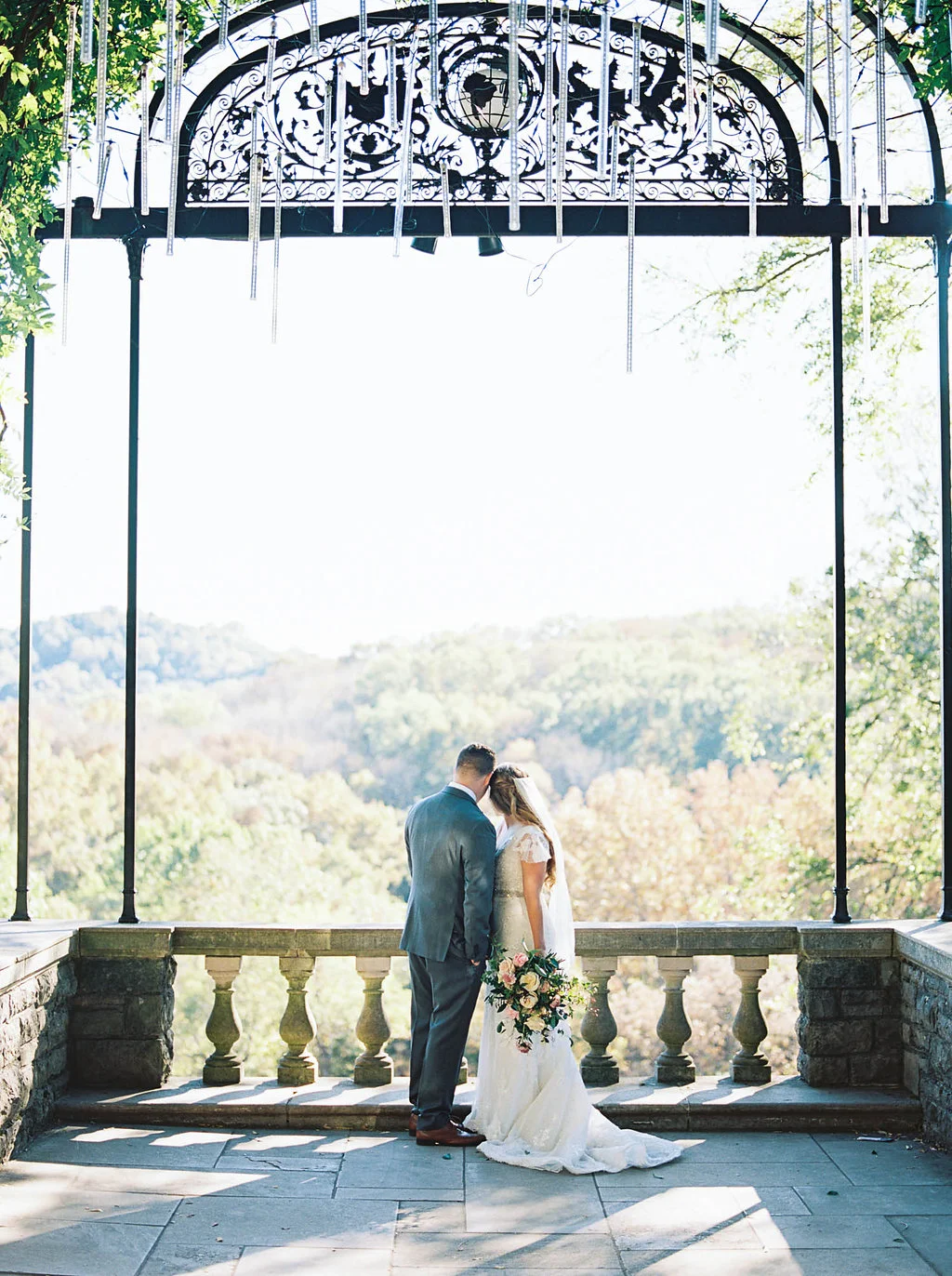 Lush, natural bridal bouquet with garden roses, tulips, blush ranunculus, and greenery in botanical garden // Nashville Wedding Florist