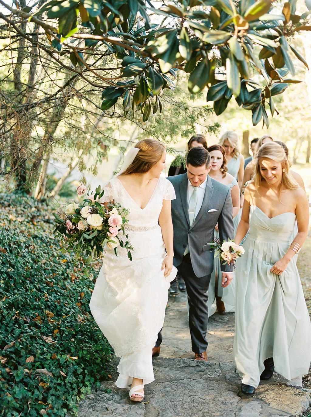Lush, natural bridal bouquet with garden roses, tulips, blush ranunculus, and greenery in botanical garden // Southern Wedding Floral Design