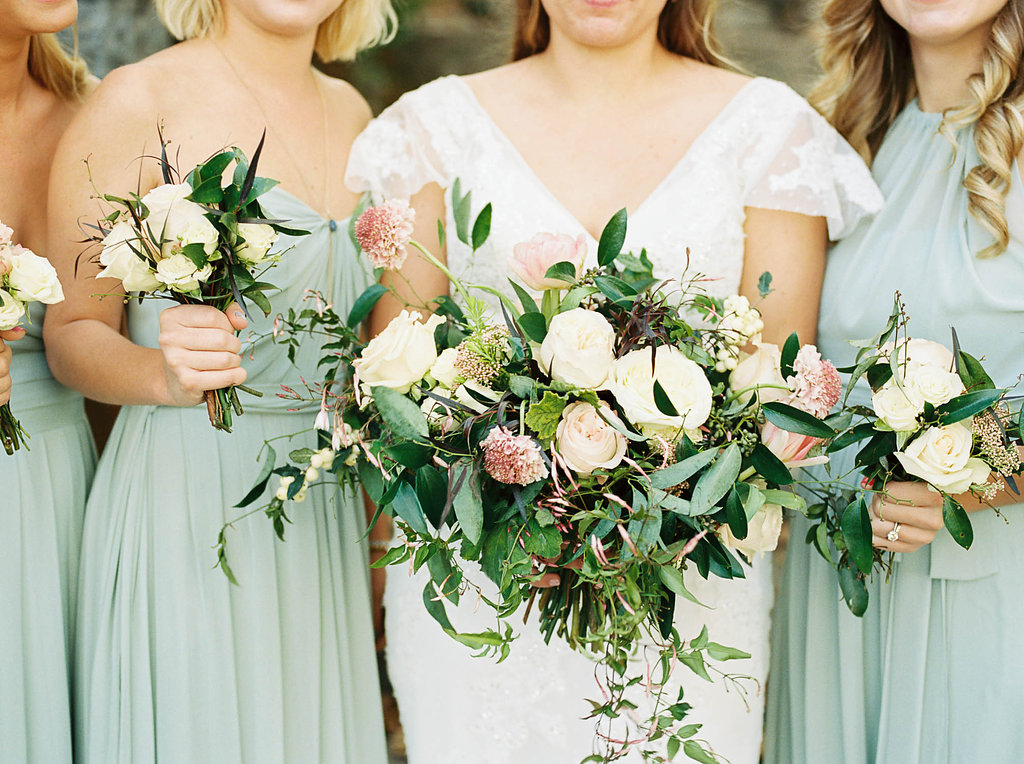 Lush, natural bridal bouquet with garden roses, tulips, blush ranunculus, and greenery in botanical garden // Southern Wedding Floral Design
