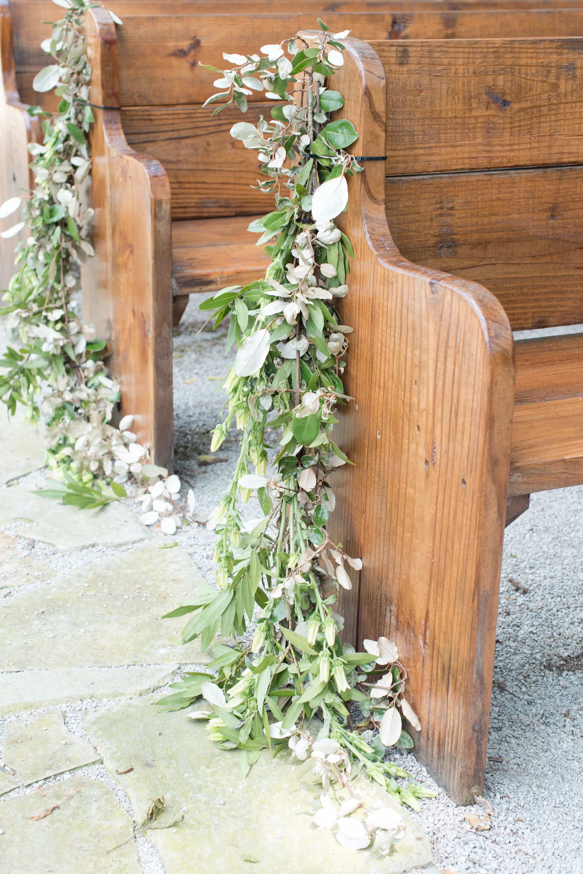 Trailing greenery aisle markers on wooden pews // Nashville Wedding Floral Design