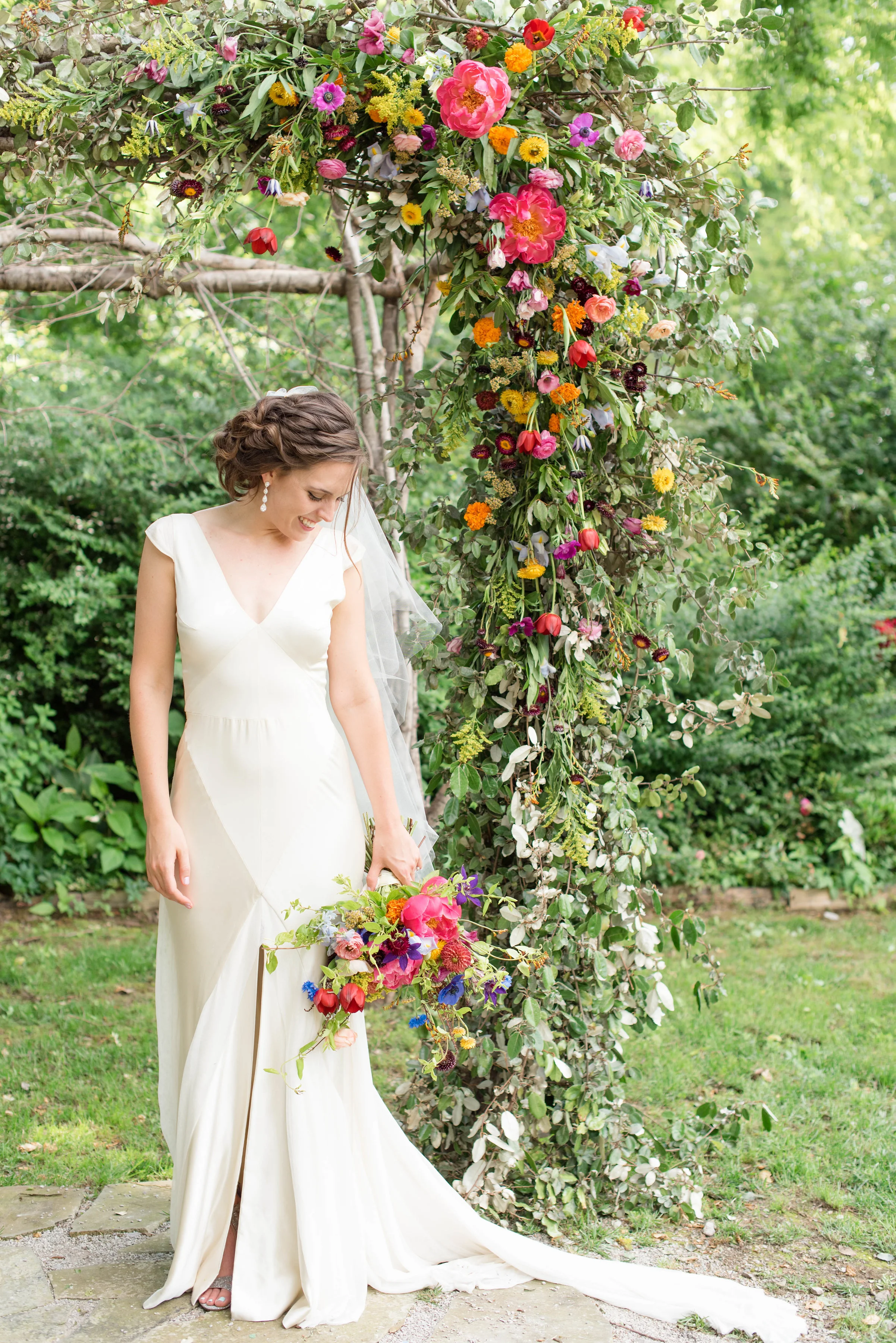 Lush, bright bridal bouquet with peonies, ranunculus, tulips, and cornflower // Chagall Painting Inspired Wedding Flowers