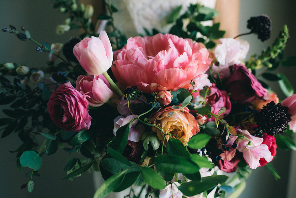 Lush bridal bouquet with coral charm peonies, tulips, ranunculus, and sweet peas // Nashville Wedding Floral Designer