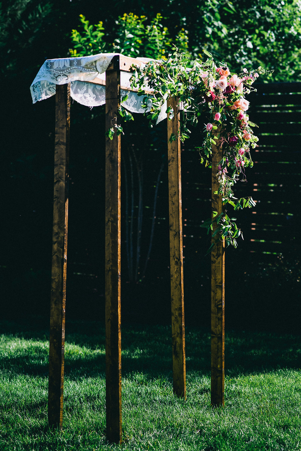 Simple wooden chuppah with heirloom lace and lush, brightly colored florals // Nashville Wedding Floral Designer