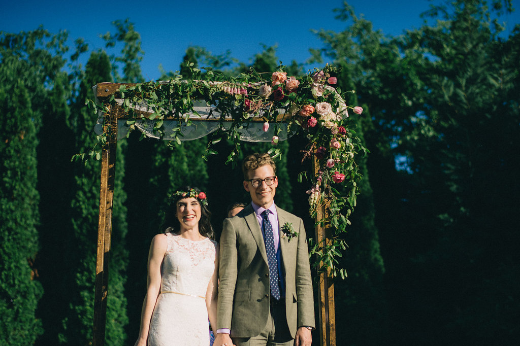 Simple wooden chuppah with heirloom lace and lush, brightly colored florals // Nashville Wedding Floral Designer