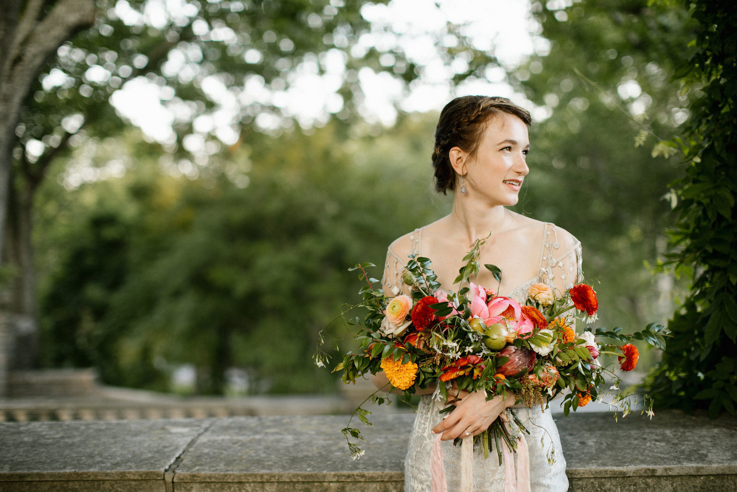 Red, coral, golden yellow, and orange bridal bouquet with lush, untamed greenery // Nashville Wedding Florist