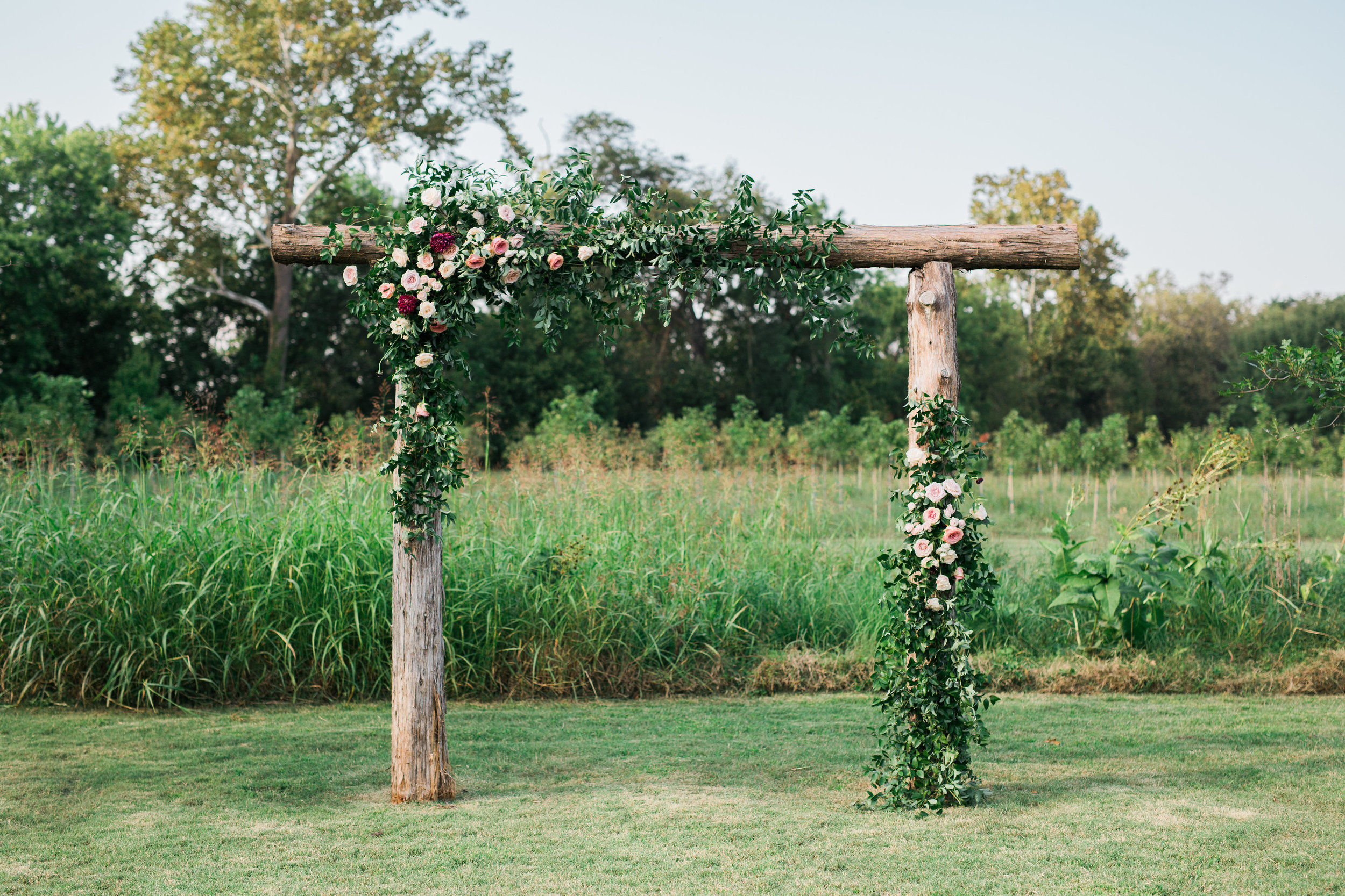Simple wooden arbor with lush floral in shades of marsala and blush // Nashville Wedding Floral Design