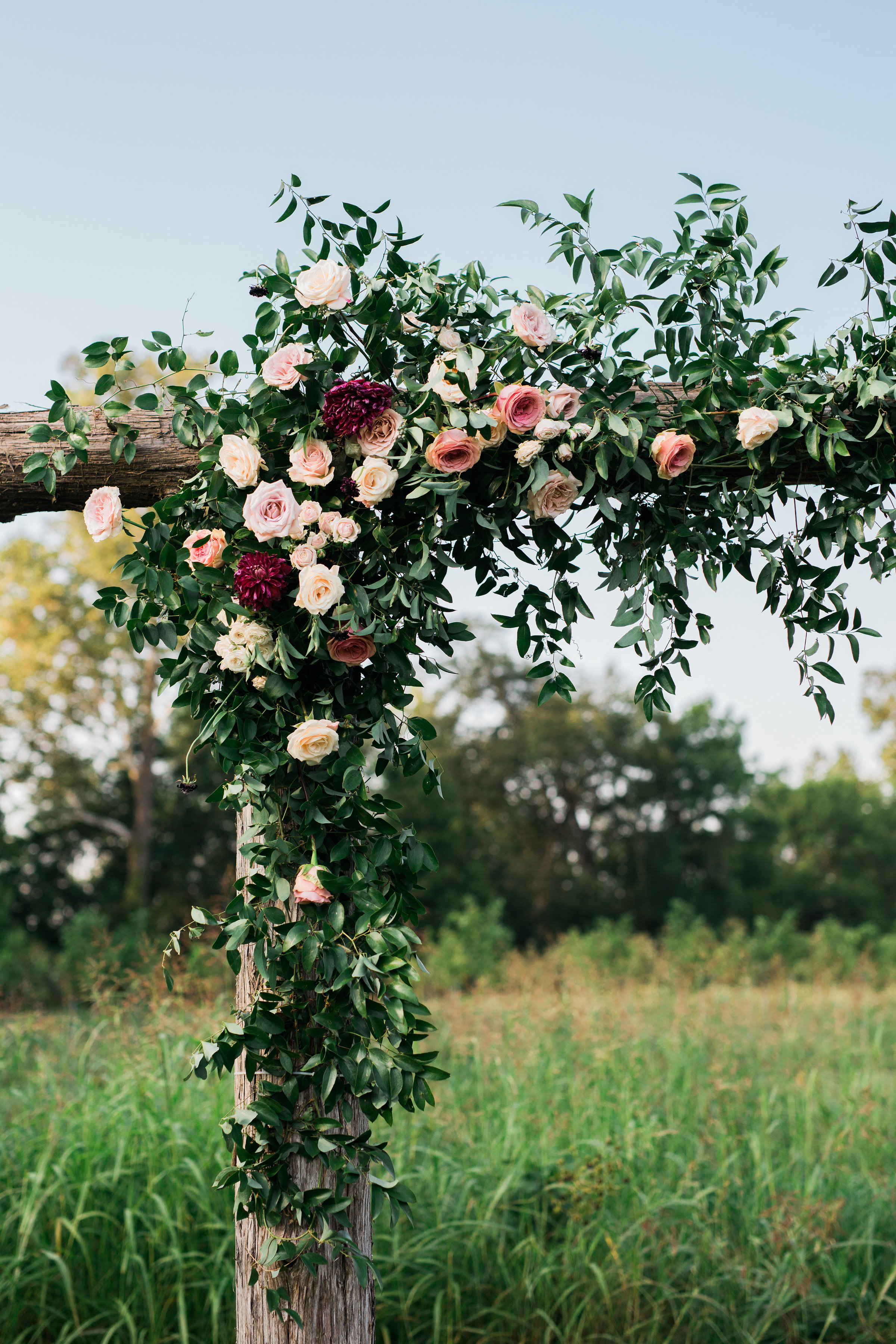 Simple wooden arbor with lush floral in shades of marsala and blush // Nashville Wedding Floral Design