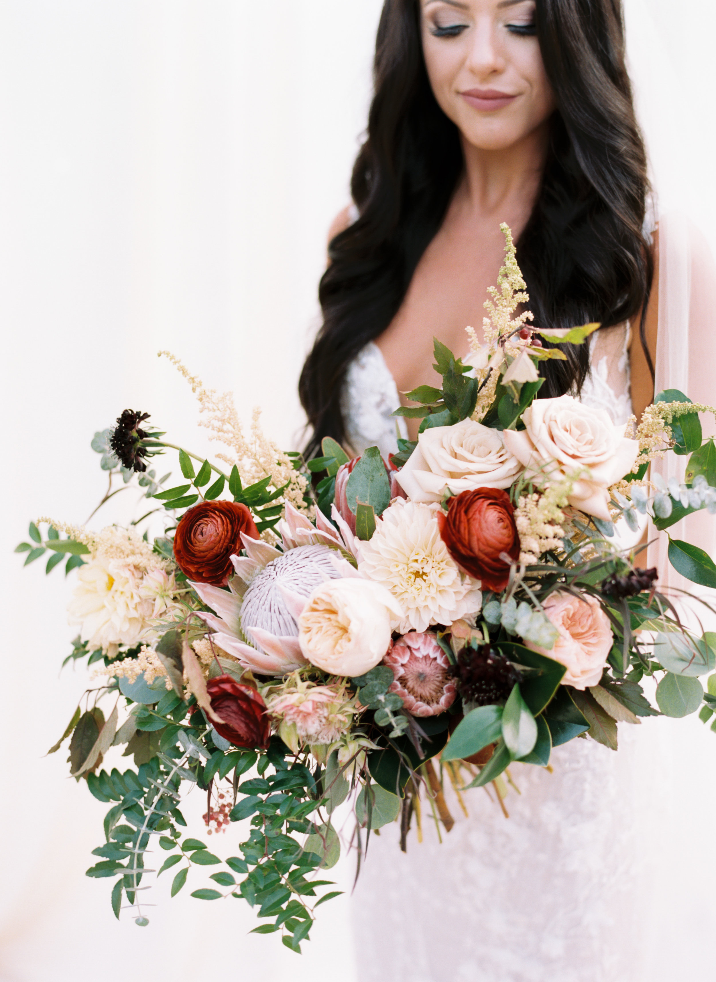 Organic, lush bridal bouquet with protea, ranunculus, and garden roses // Nashville Wedding Floral Design