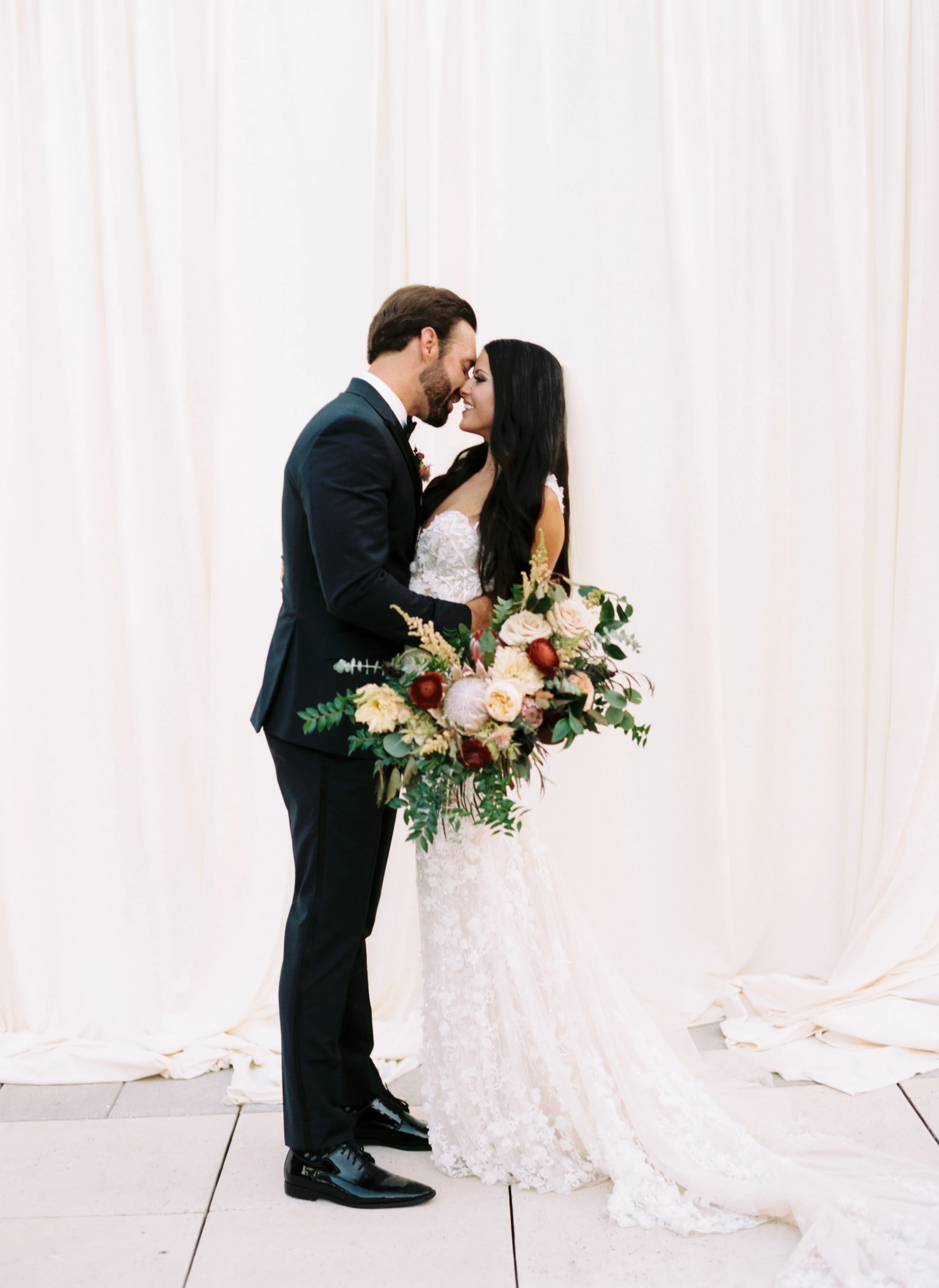 Blush and marsala wedding flowers with protea, ranunculus, and lots of greenery and texture // Country Music Hall of Fame Wedding, Nashville
