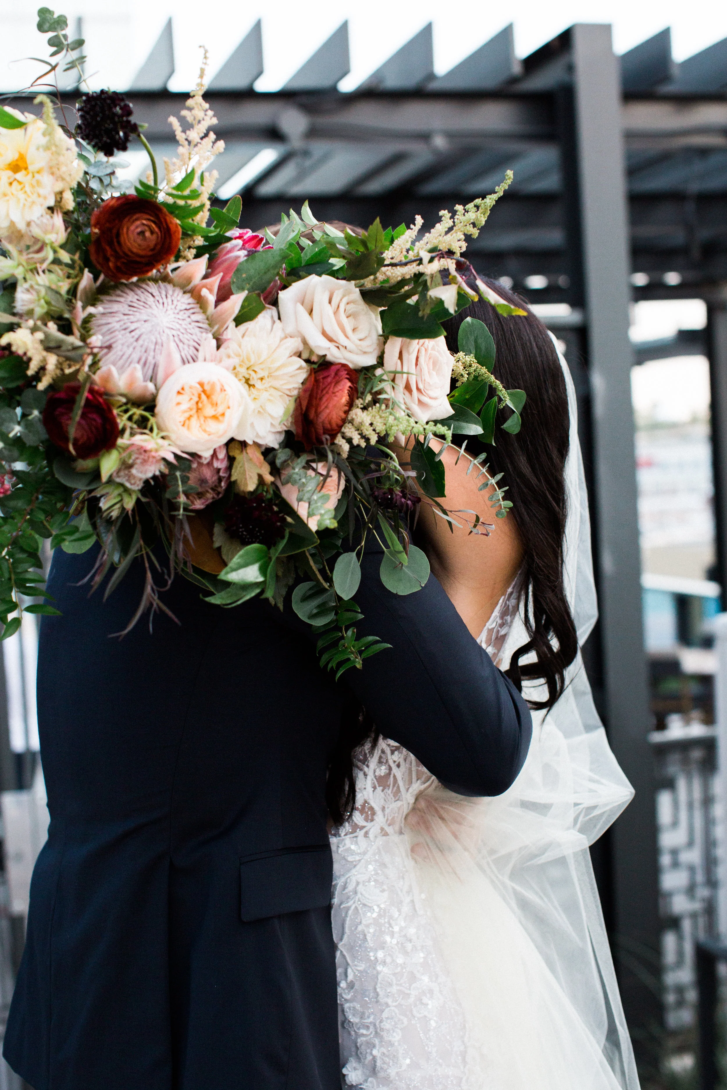 Blush and marsala wedding flowers with protea, ranunculus, and lots of greenery and texture // Country Music Hall of Fame Wedding, Nashville
