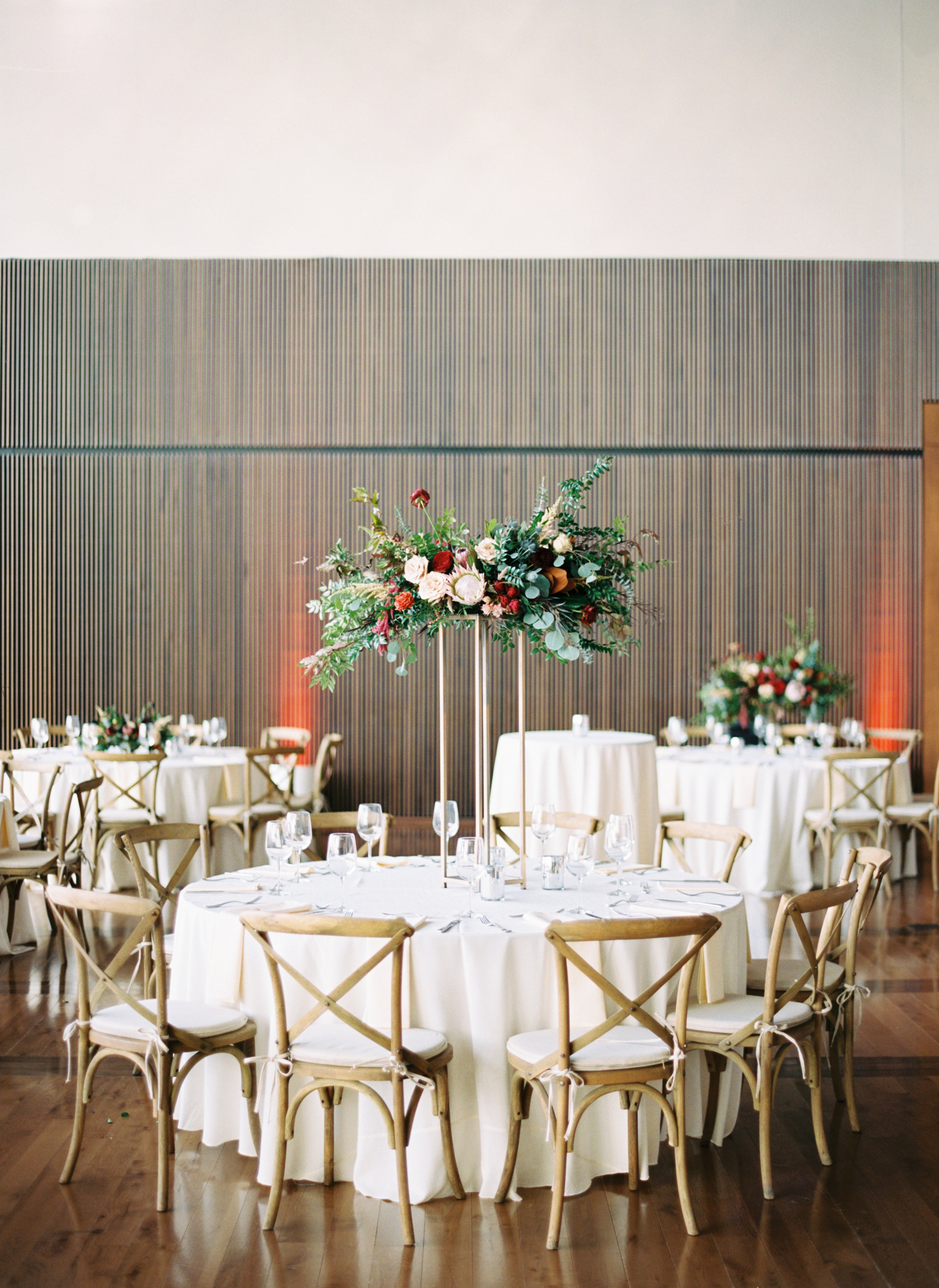 Blush and marsala centerpieces with protea, ranunculus, and lush greenery // Country Music Hall of Fame Wedding, Nashville
