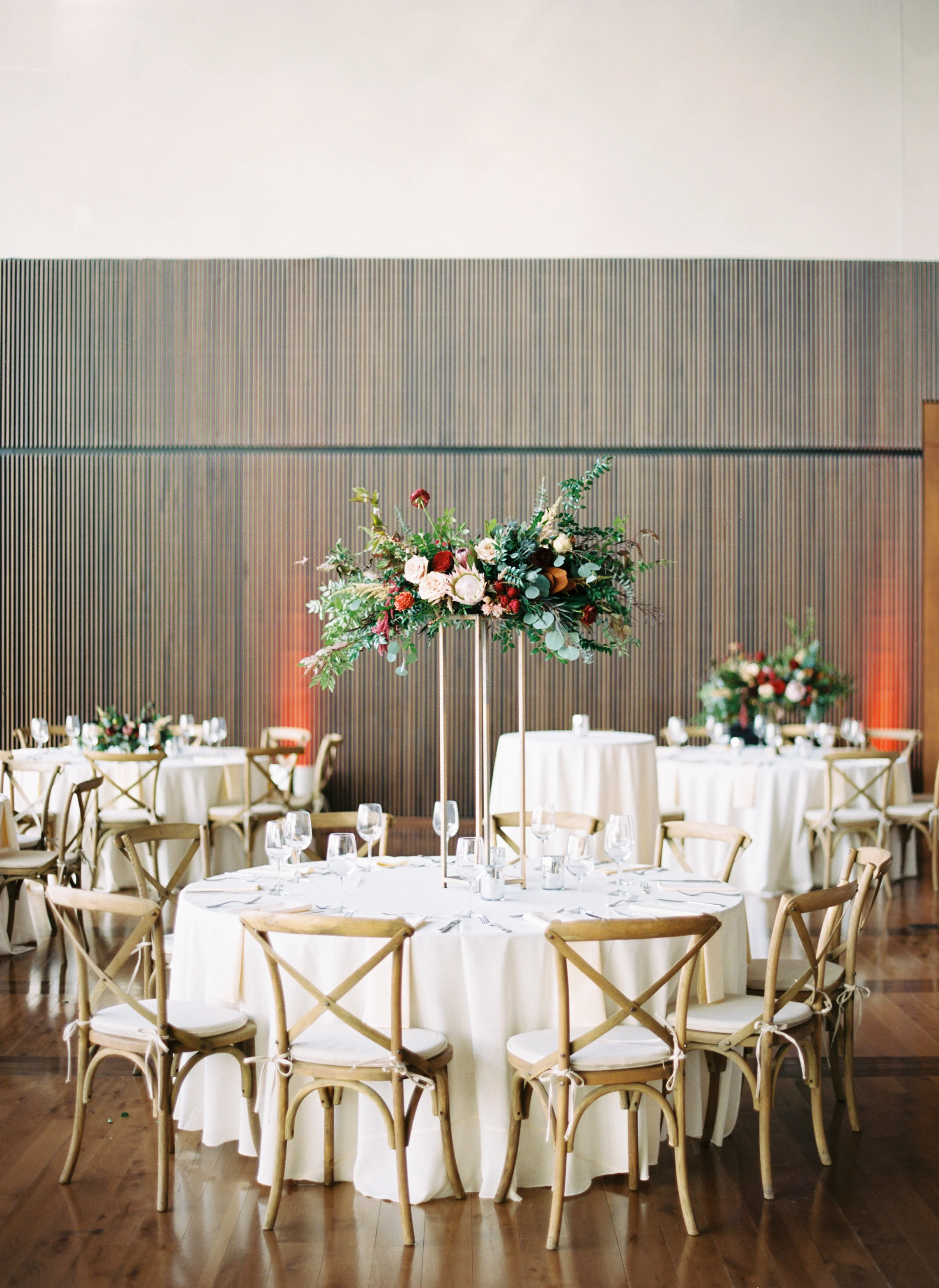 Blush and marsala centerpieces with protea, ranunculus, and lush greenery // Country Music Hall of Fame Wedding, Nashville