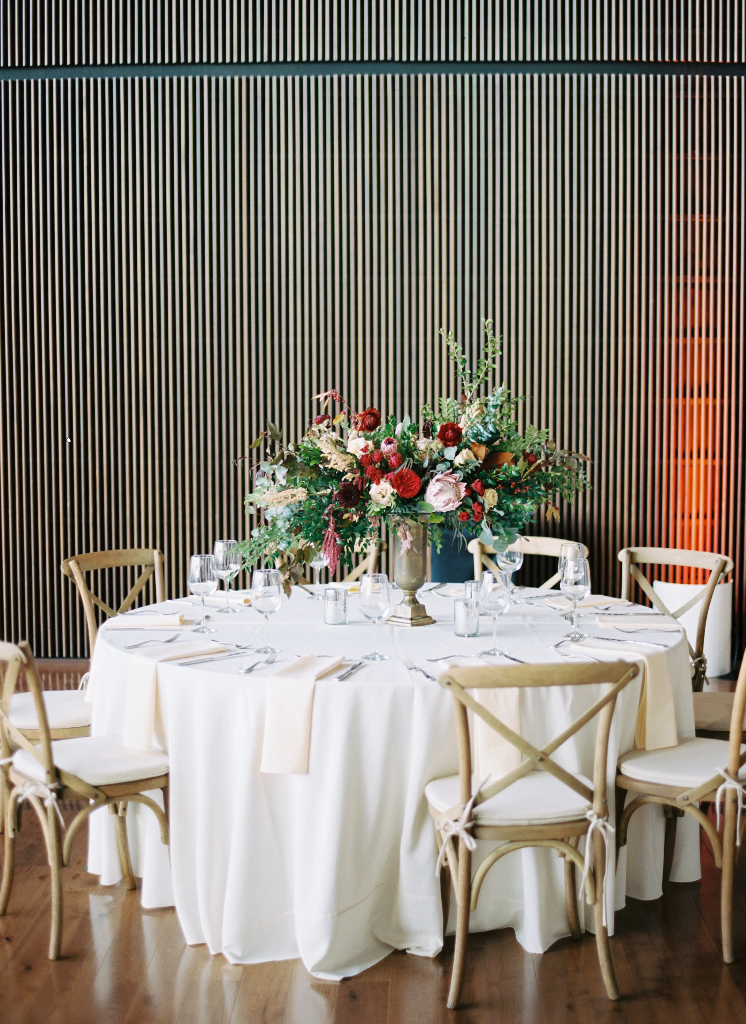Blush and marsala centerpieces with protea, ranunculus, and lush greenery // Country Music Hall of Fame Wedding, Nashville
