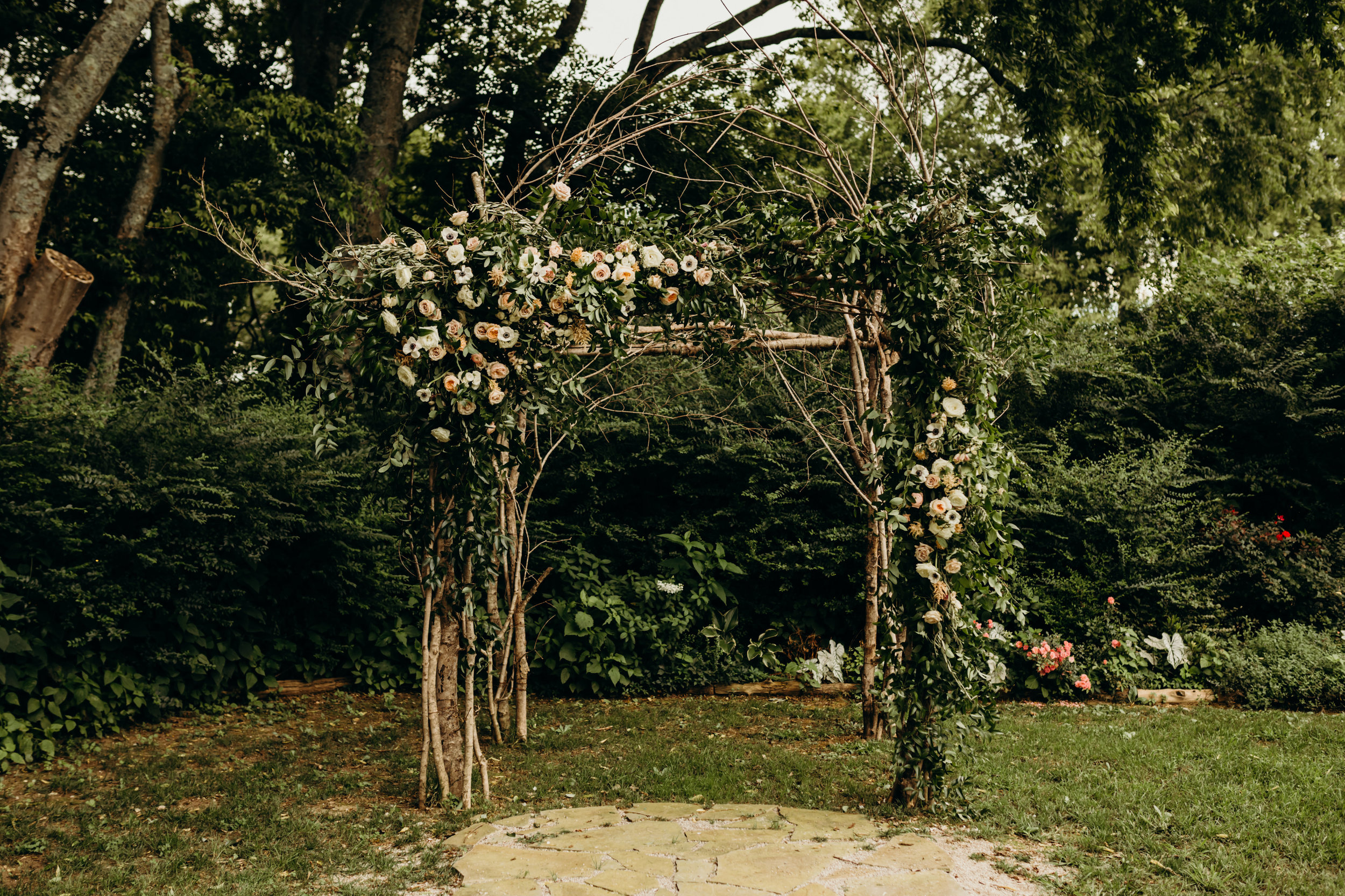 Branchy arbor with lush, untamed greenery and blush flowers // Nashville Wedding Florist