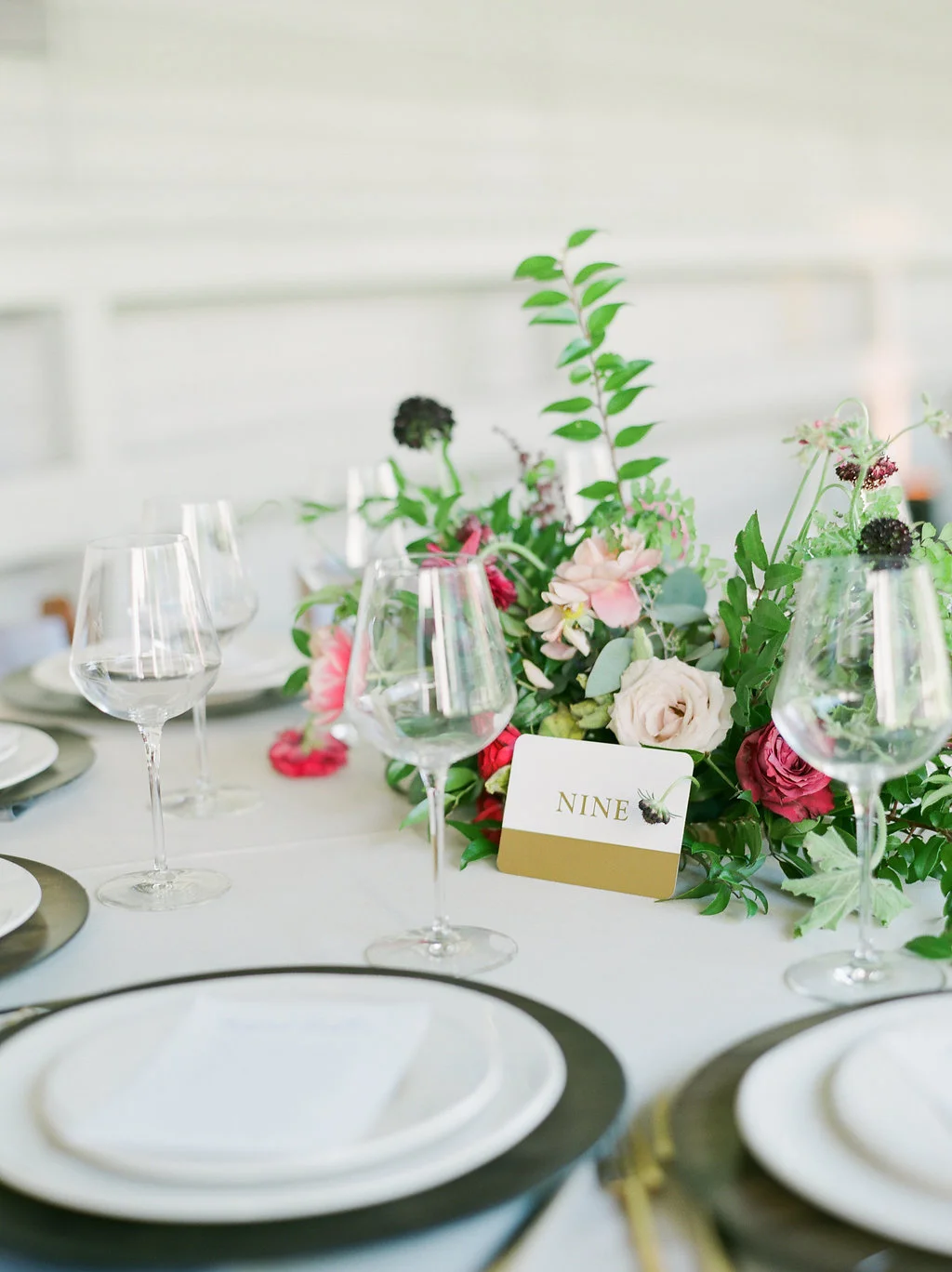 Raspberry and marsala floral centerpiece with ranunculus, tulips, and garden roses // Nashville Wedding Florist