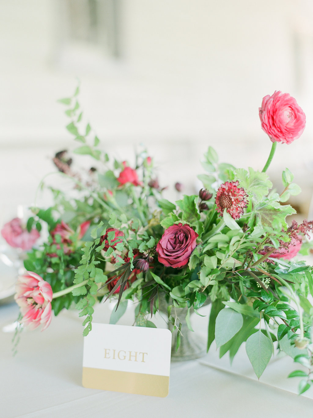 Raspberry and marsala floral centerpiece with ranunculus, tulips, and garden roses // Nashville Wedding Florist