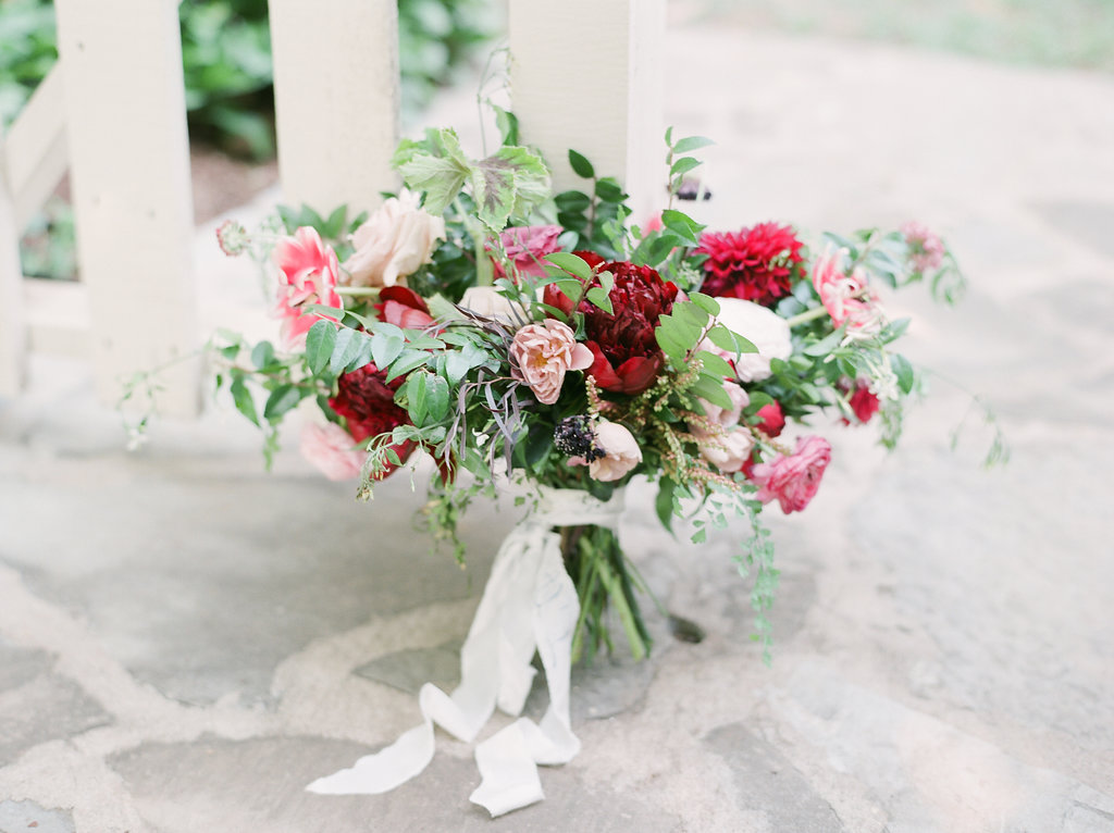 Bridal bouquet with marsala peonies, dahlias, tulips, and natural greenery