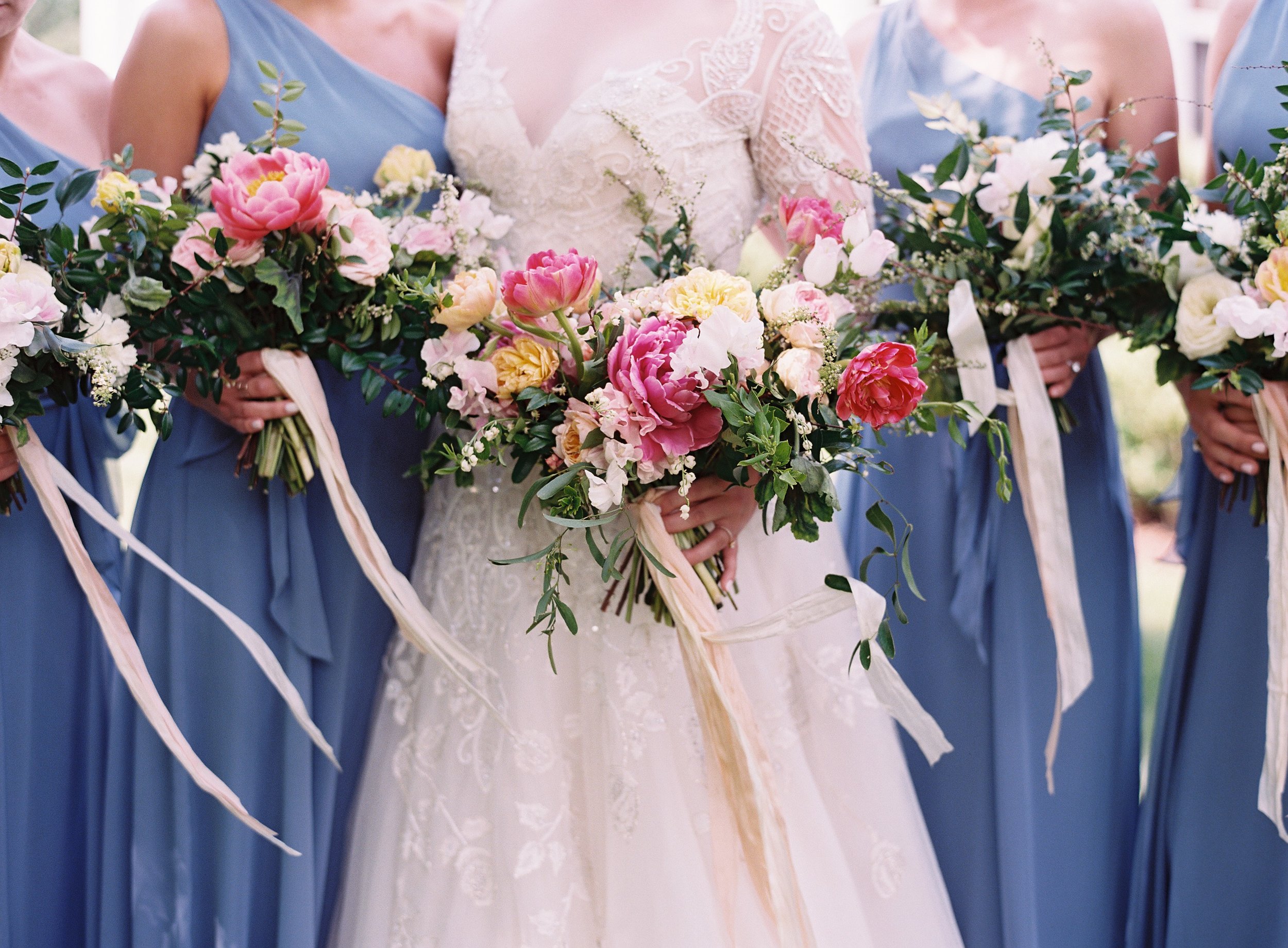 Lush bridal bouquet of peonies, tulips, lily of the valley, garden roses, and sweet peas with streaming silk ribbon // Nashville Wedding Floral Design