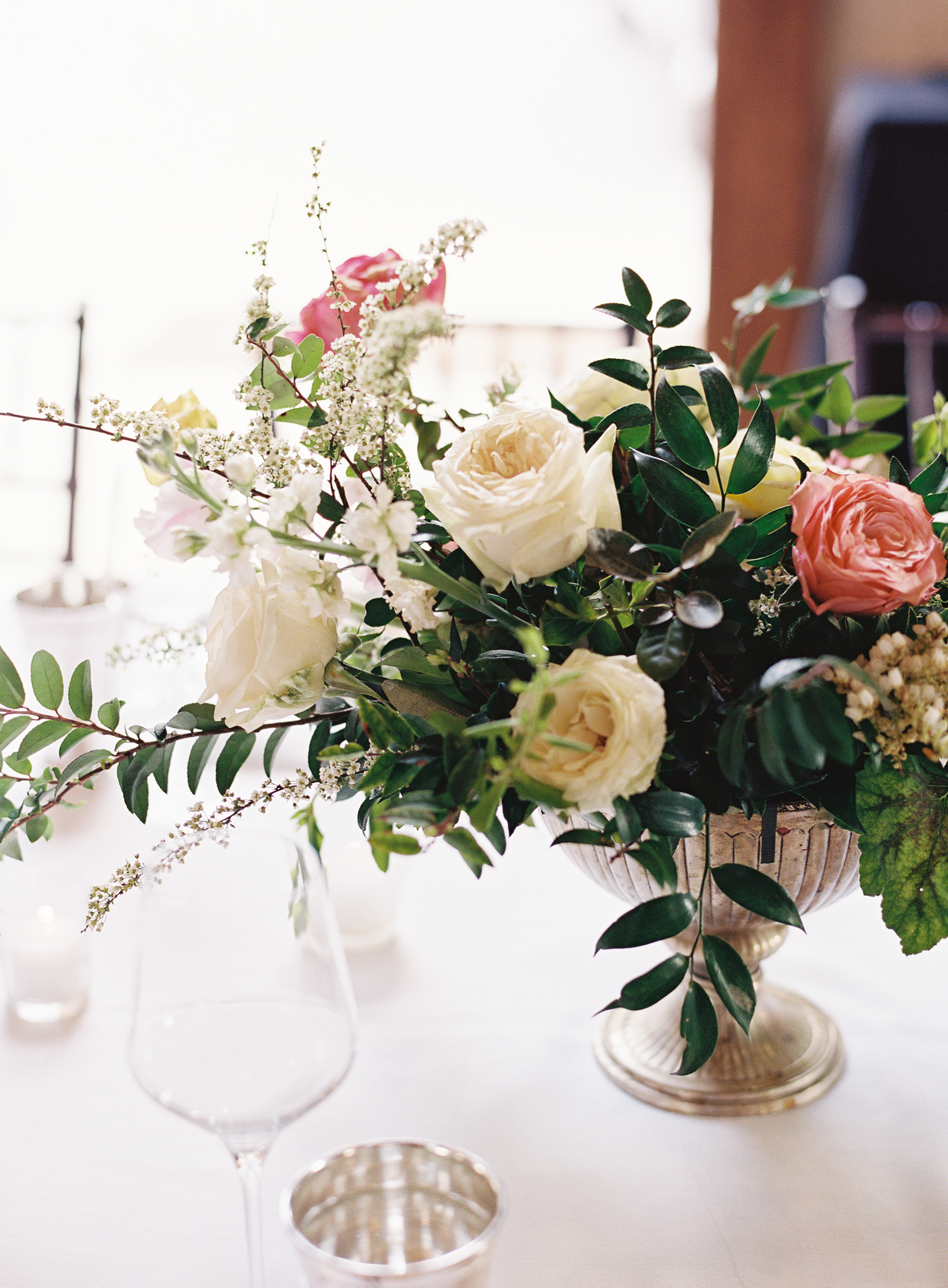 Silver compote centerpieces with natural greenery, peach garden roses, pink tulips, and spirea // Nashville Wedding Floral Design