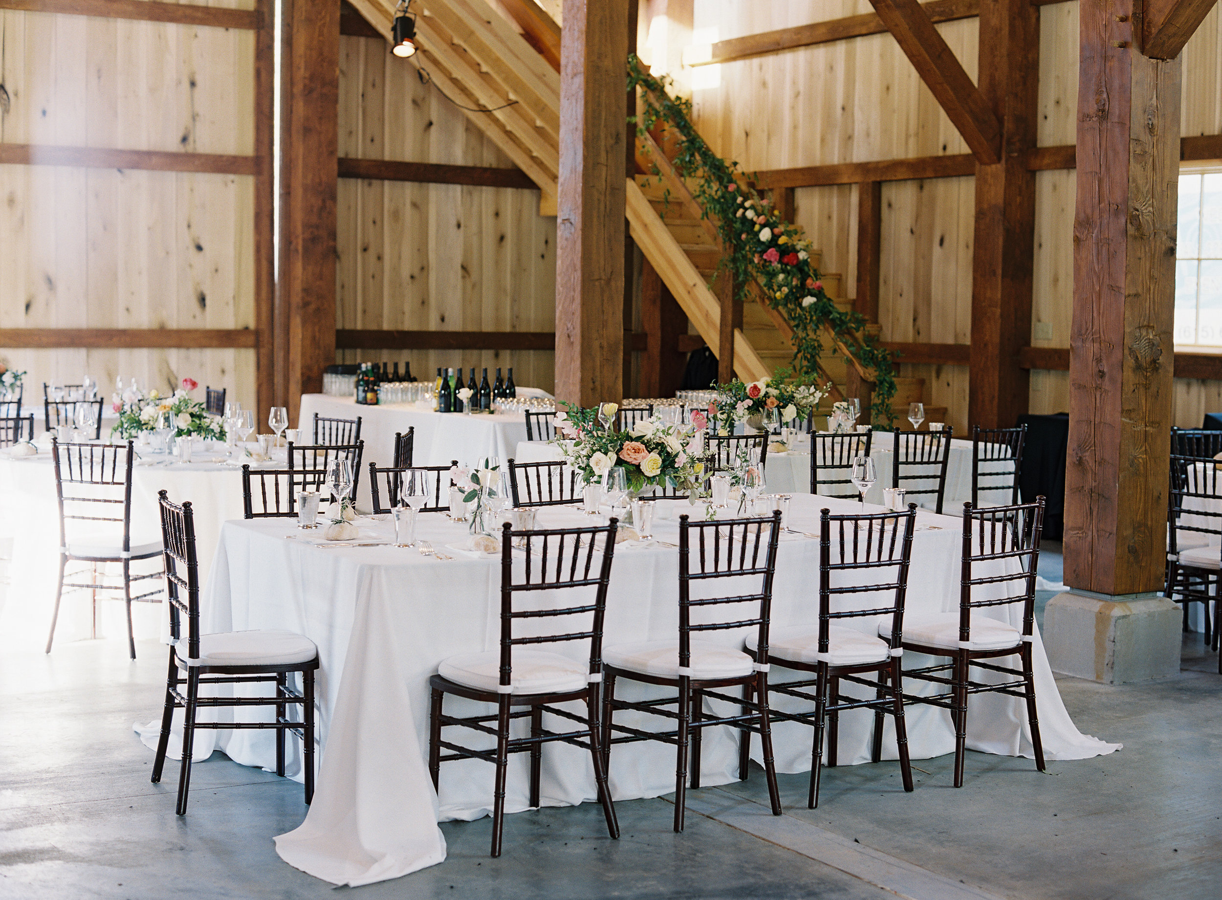Upscale barn wedding with Silver compote centerpieces with natural greenery, peach garden roses, pink tulips, and spirea // Nashville Wedding Floral Design