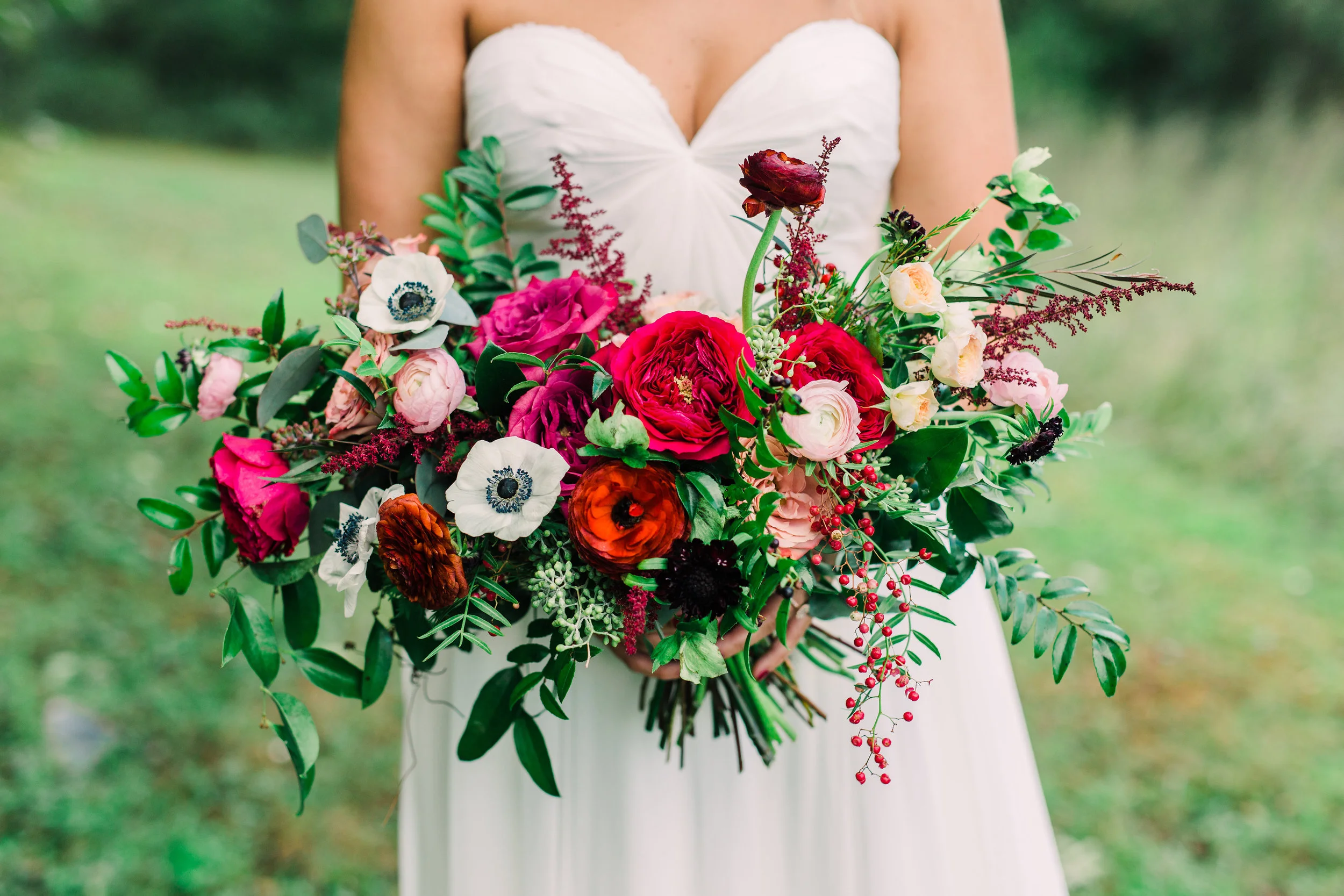 Natural bridal bouquet with marsala ranunculus, anemones, and trailing greenery // Nashville Wedding Floral Design