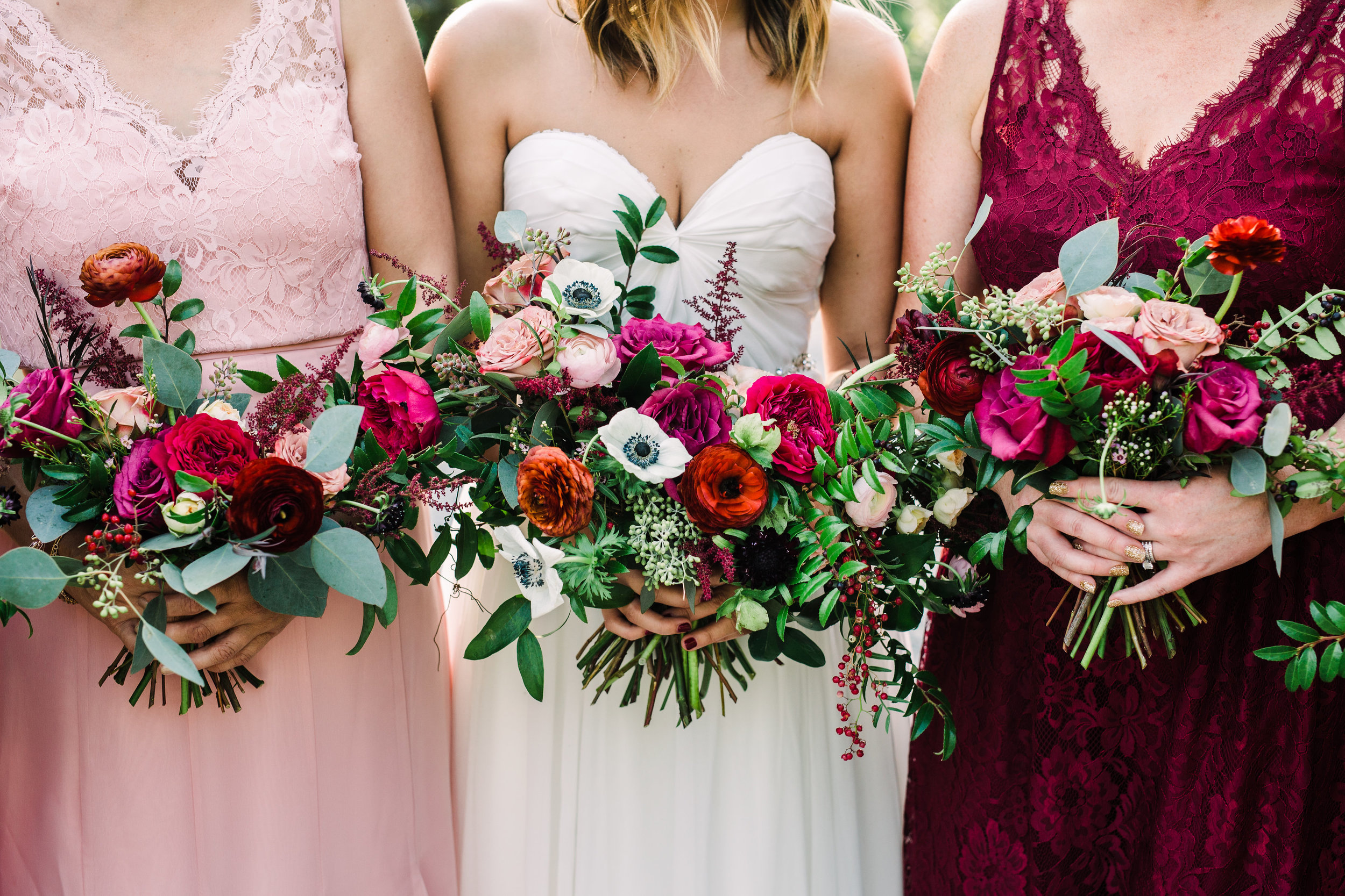 Natural bridal bouquet with marsala ranunculus, anemones, and trailing greenery // Nashville Wedding Floral Design