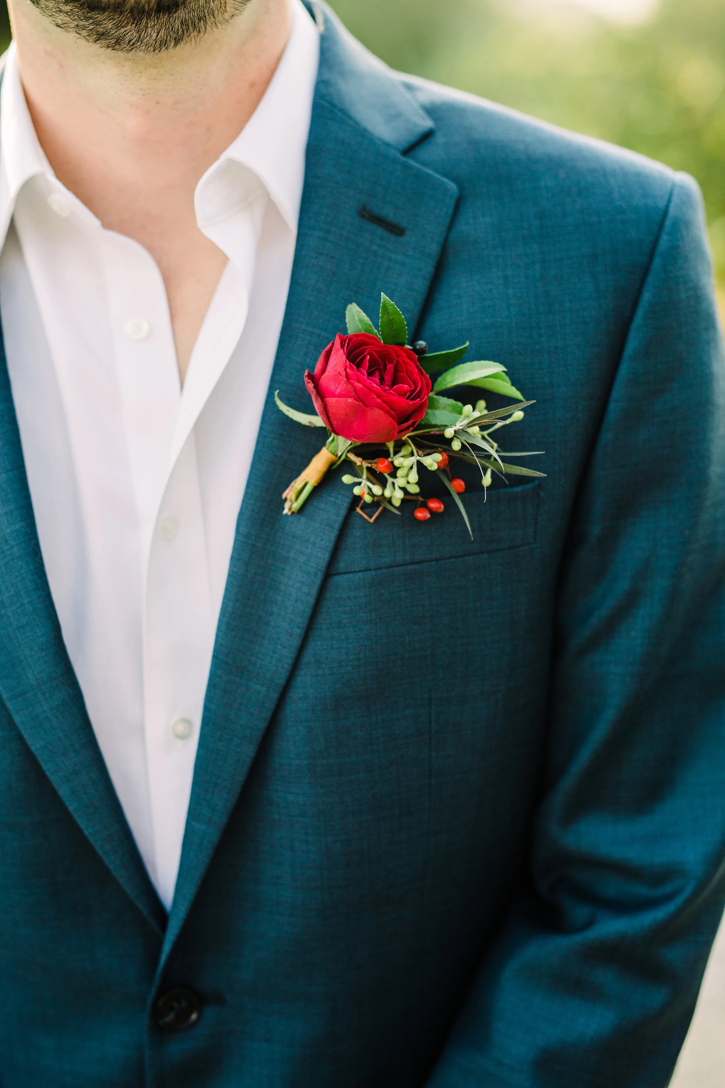 Simple burgundy and greenery groom's boutonniere