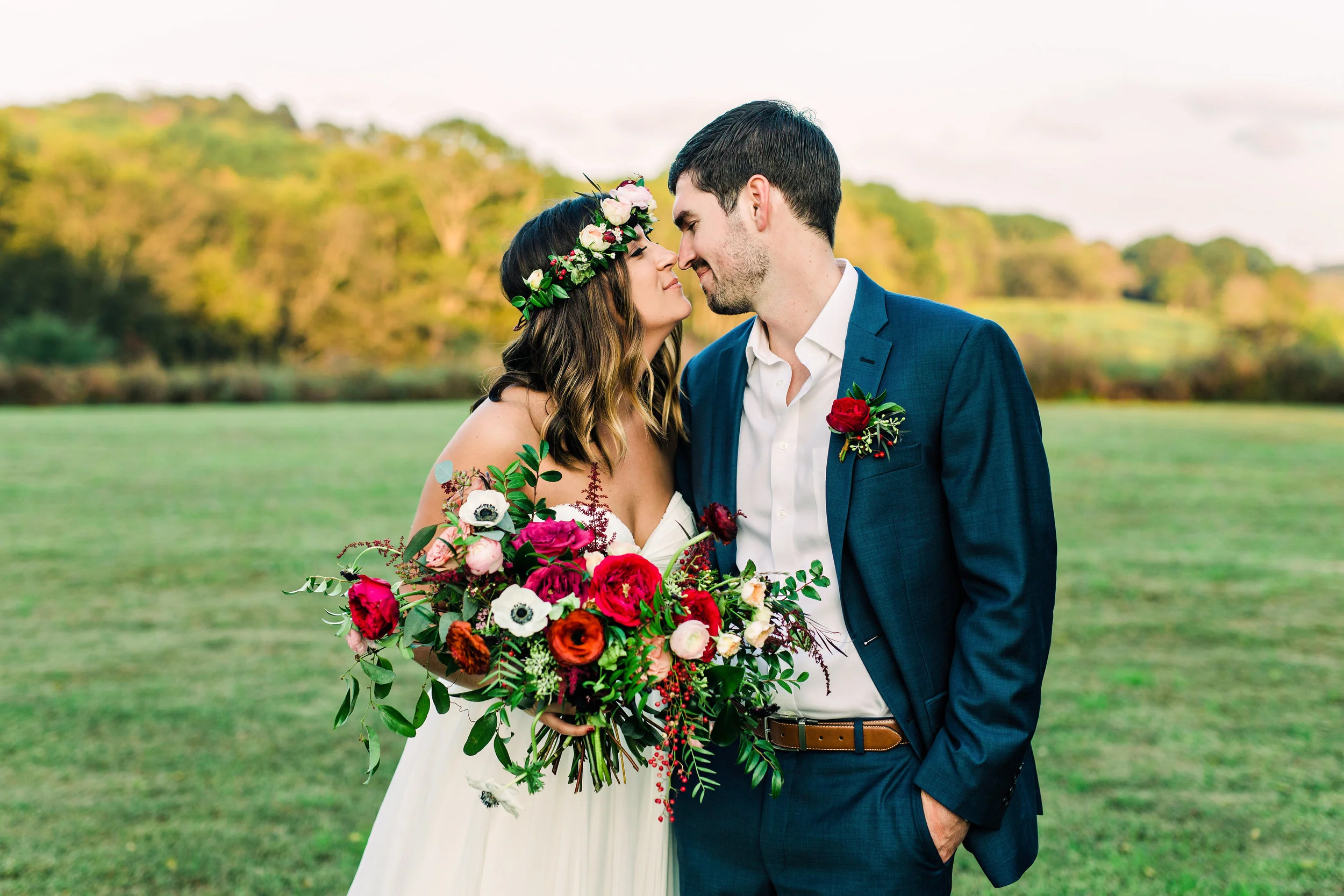 Lush, untamed wedding flowers using deep red and burgundy garden roses and ranunculus // Nashville Wedding Florist