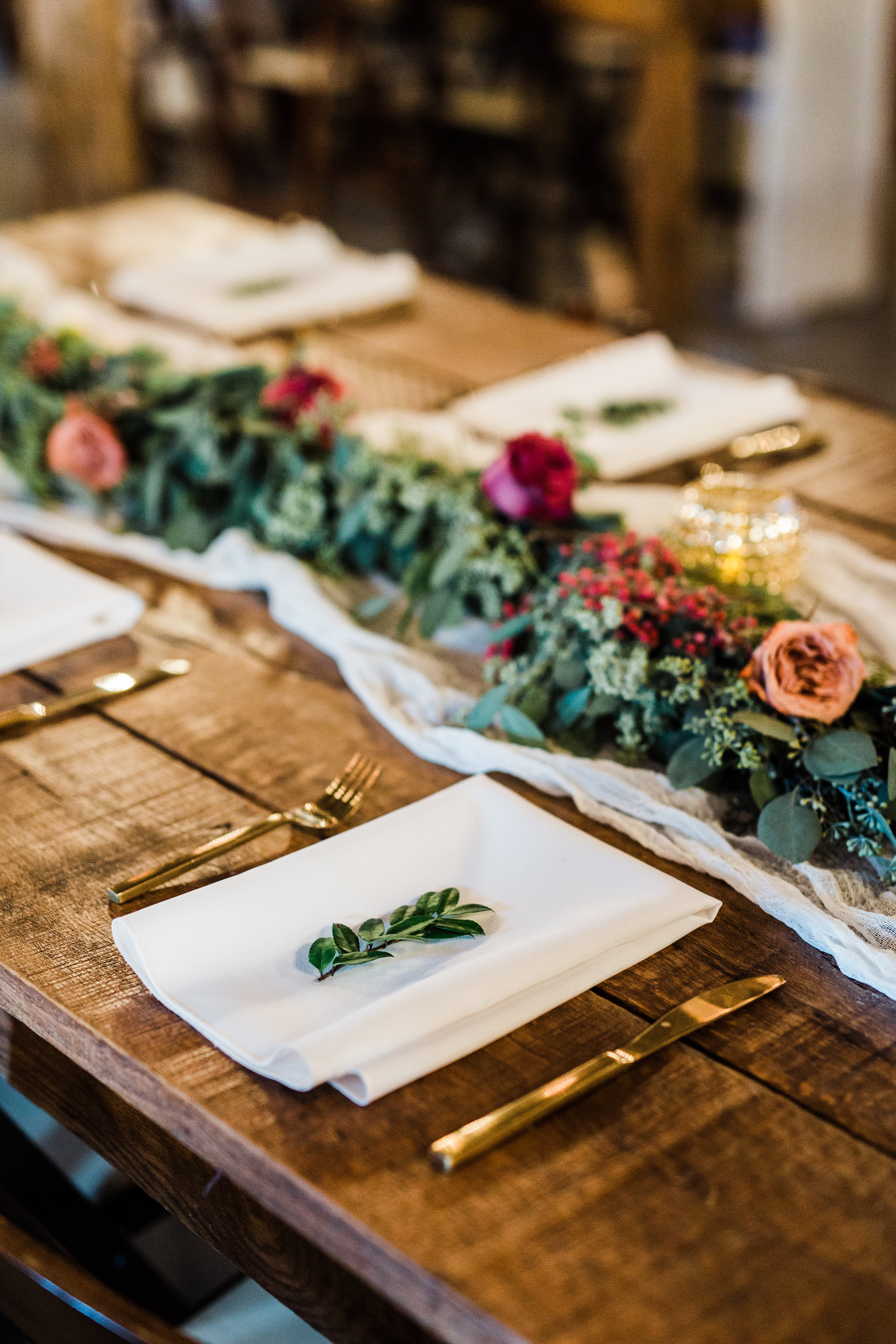 Lush greenery garlands on farm tables with marsala floral accents // Nashville Wedding Flowers