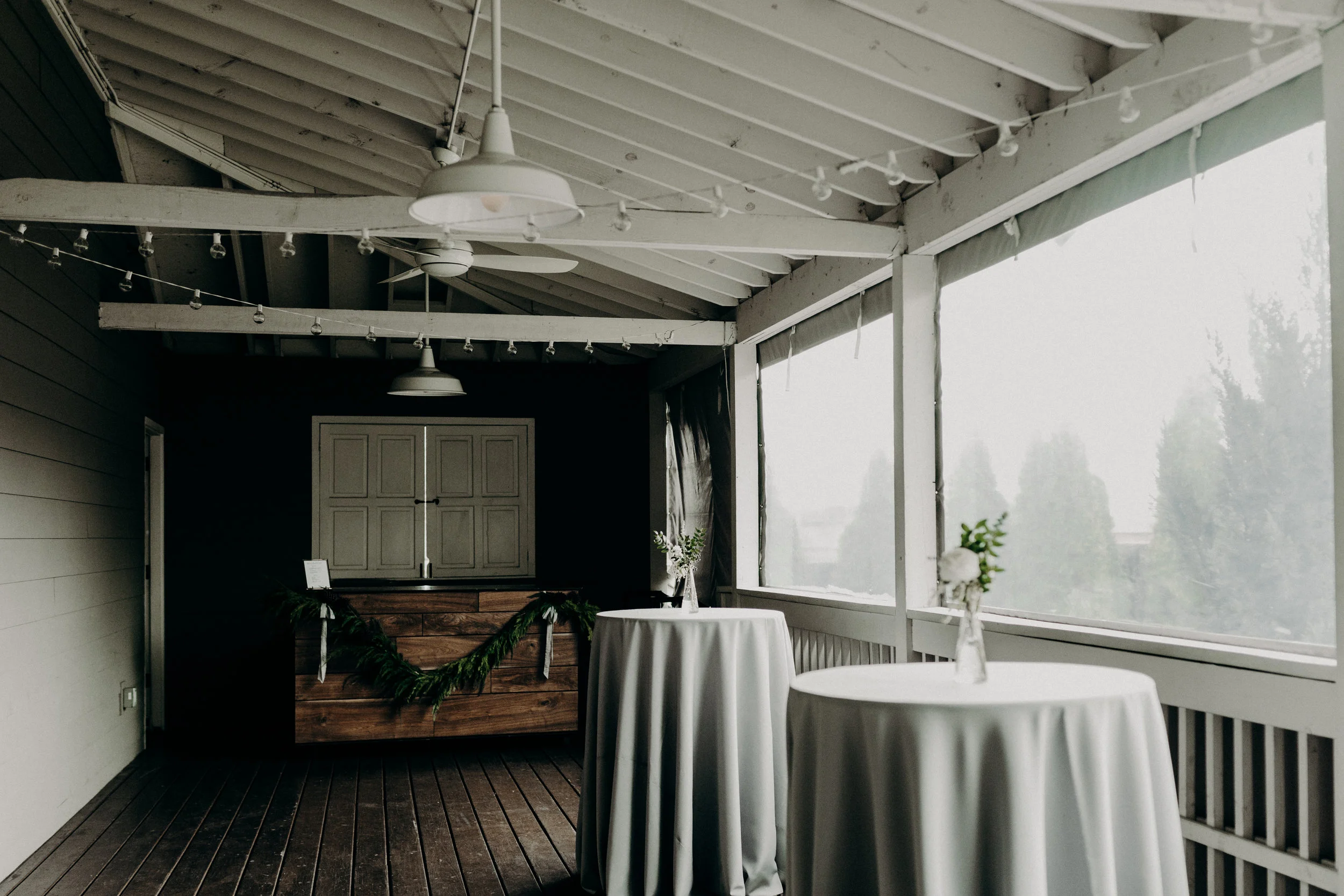 The Cordelle Porch--cedar garland and silk ribbon on the bars // Nashville Floral Design