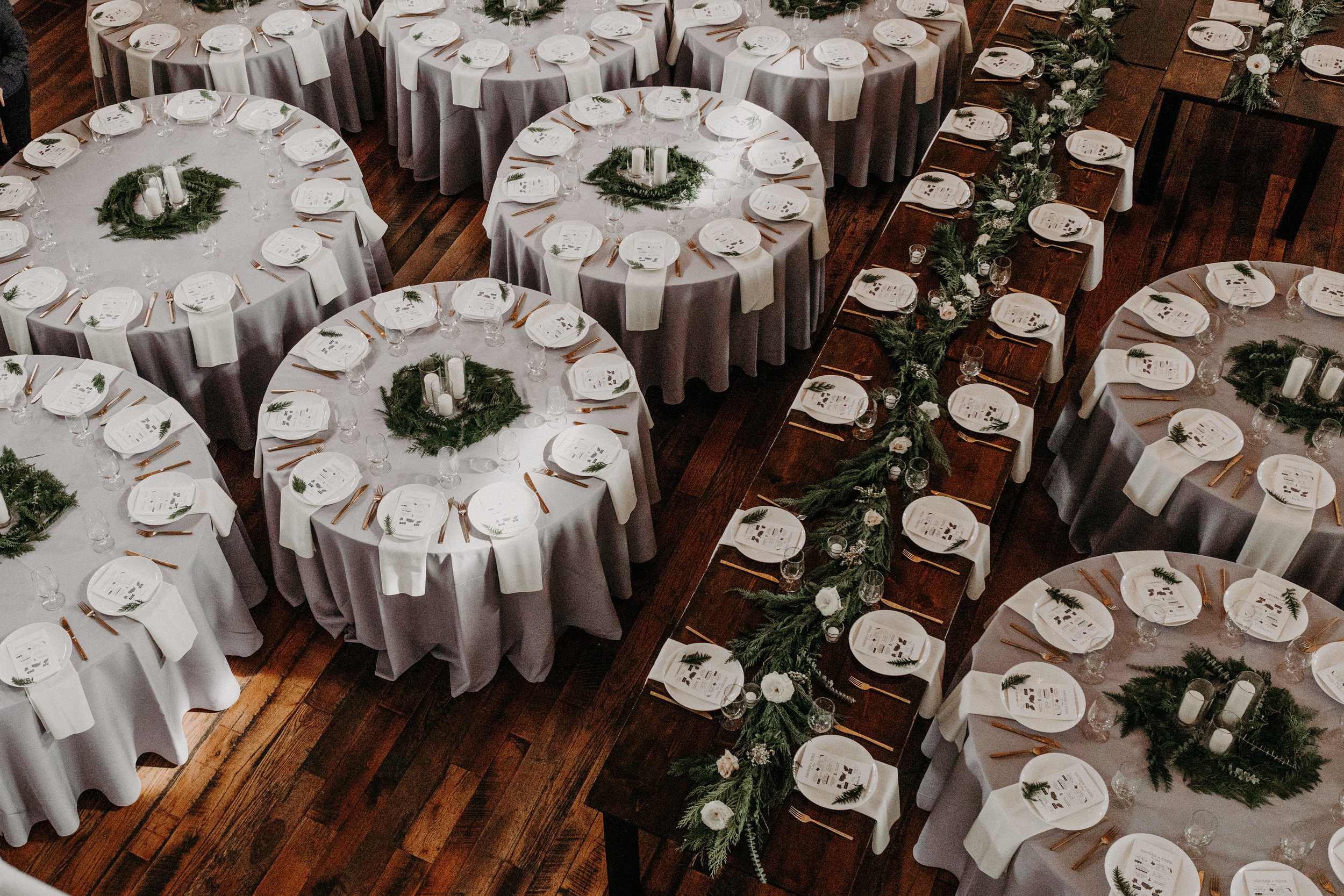 Loose greenery and white pillar candles centerpieces // Nashville Wedding Floral Design