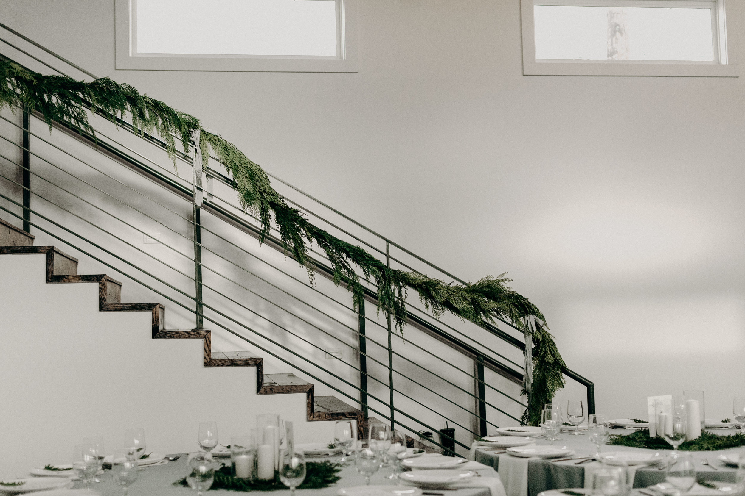 Cedar garland draping the stairwell at the Cordell // Nashville Wedding Floral Design