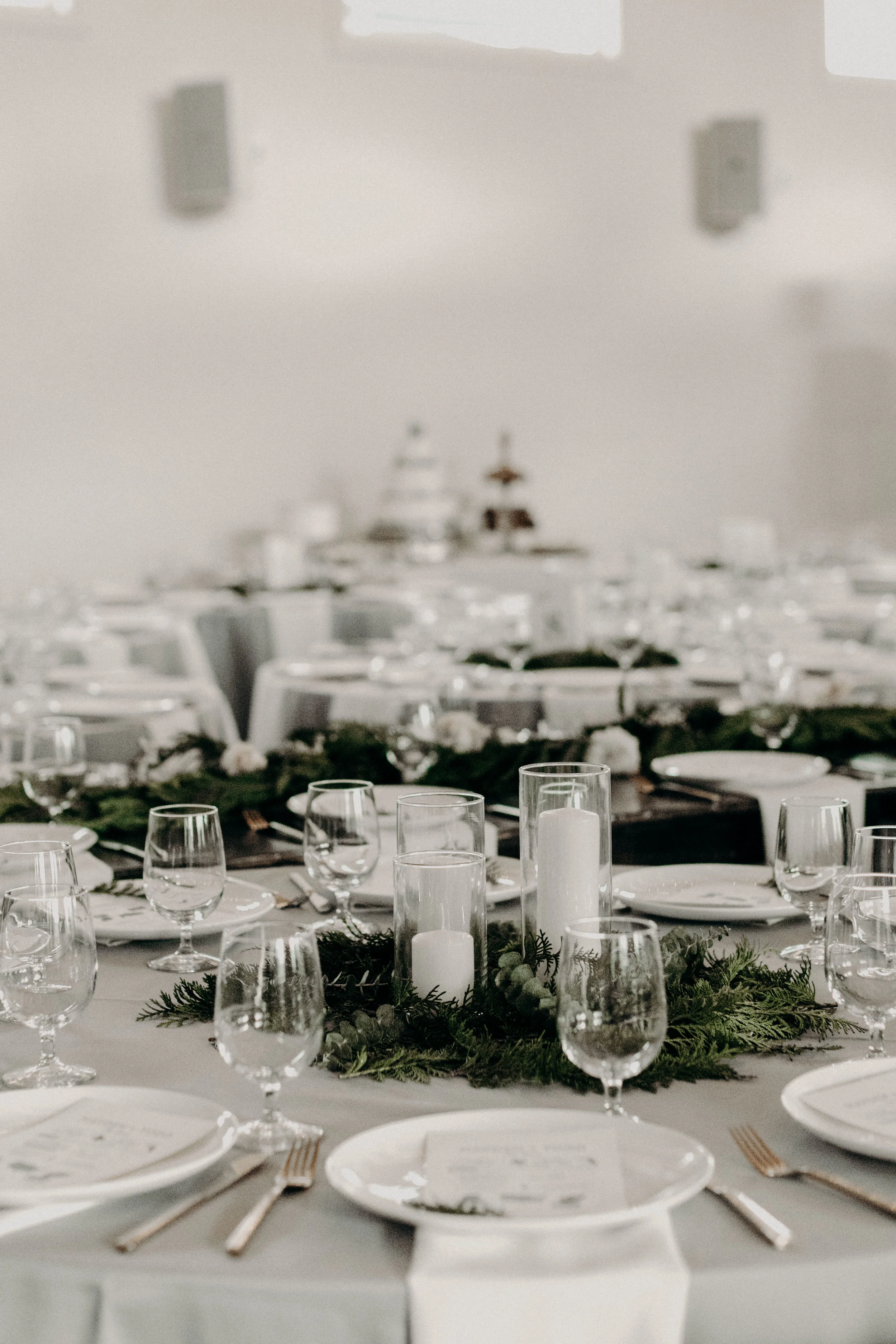Alaska inspired winter wedding // Lush greenery centerpieces with white pillar candles  // Nashville Wedding Florist