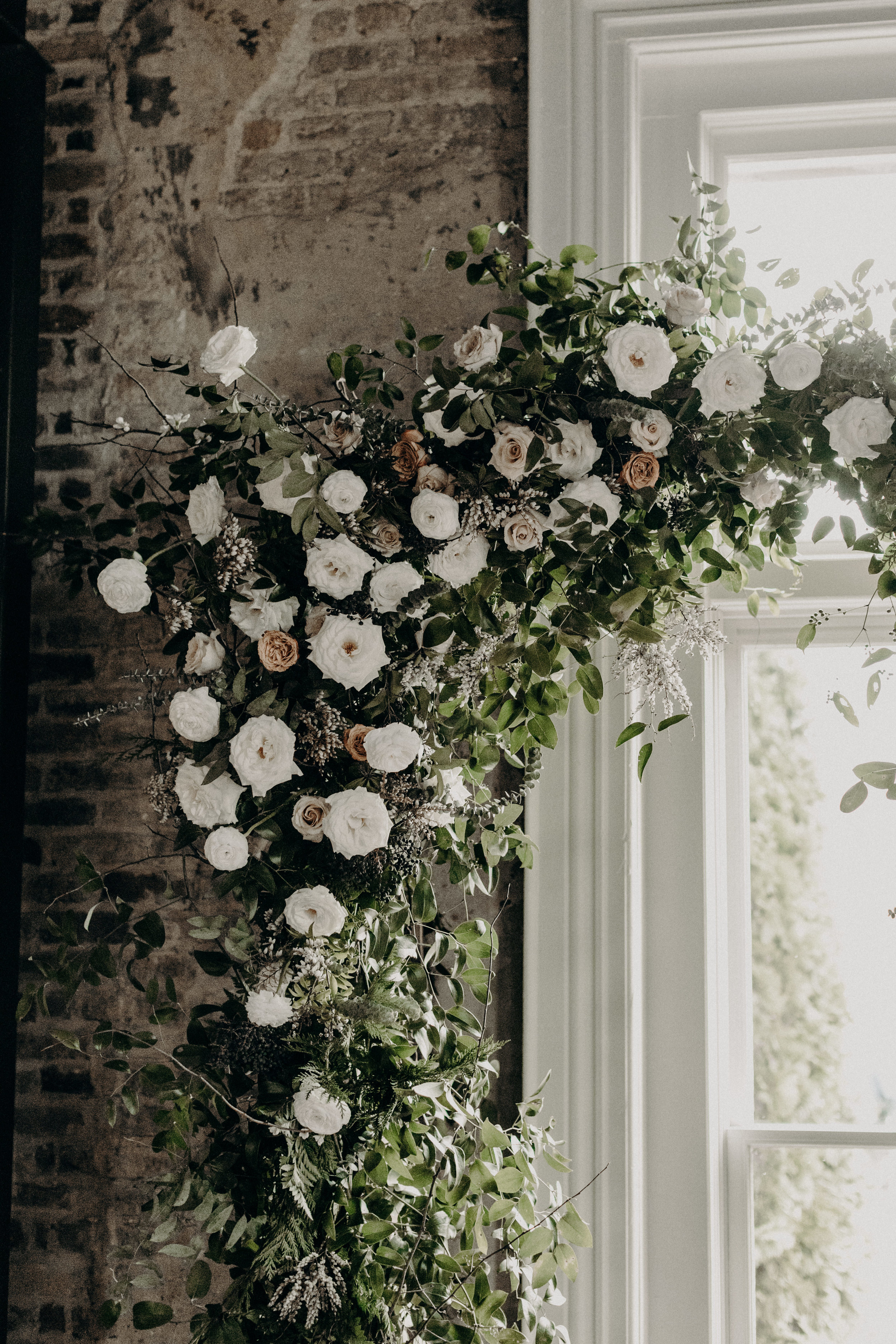Wedding Ceremony arbor with lush greenery and white and neutral flowers // Alaska inspired winter wedding // Nashville Wedding Florist
