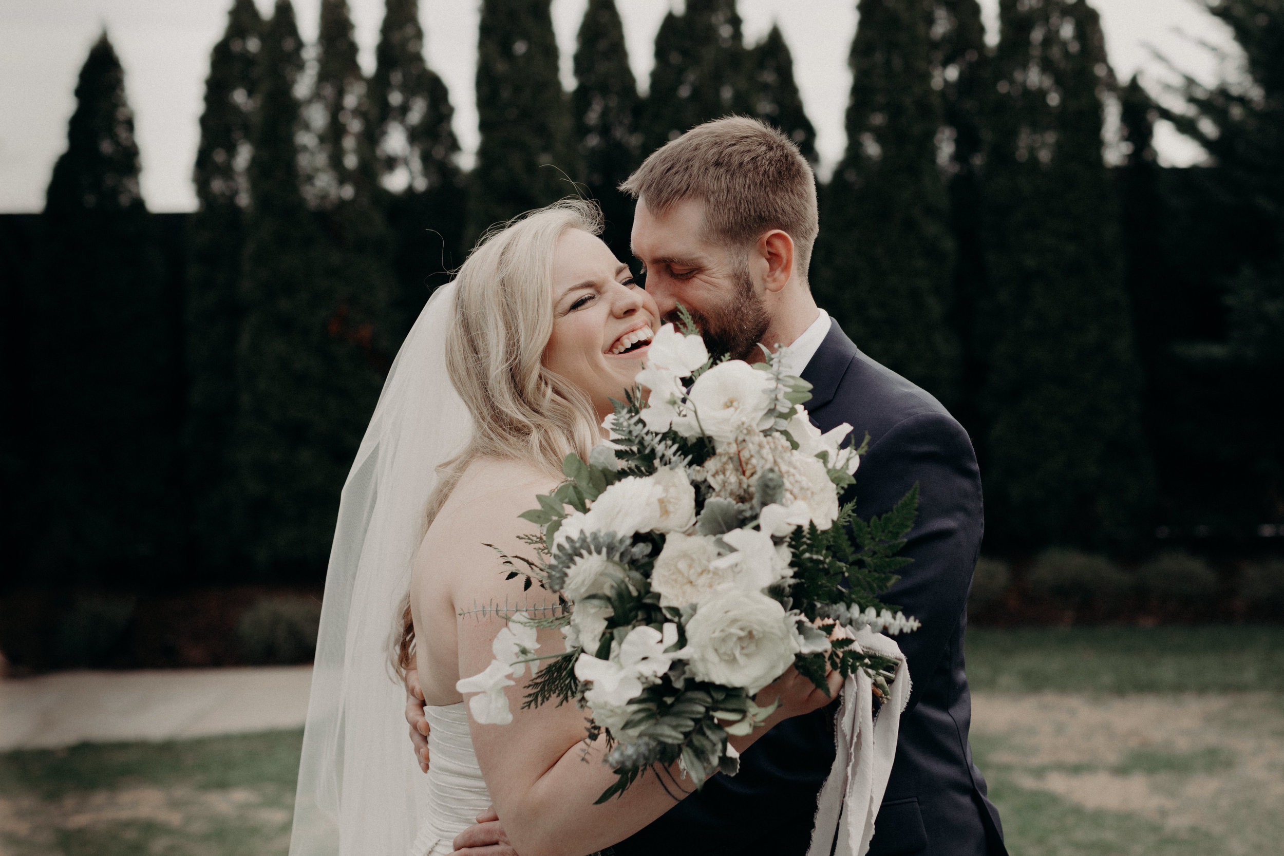 Lush winter bridal bouquet with all white flowers and evergreen accents  // Nashville Wedding Floral Design