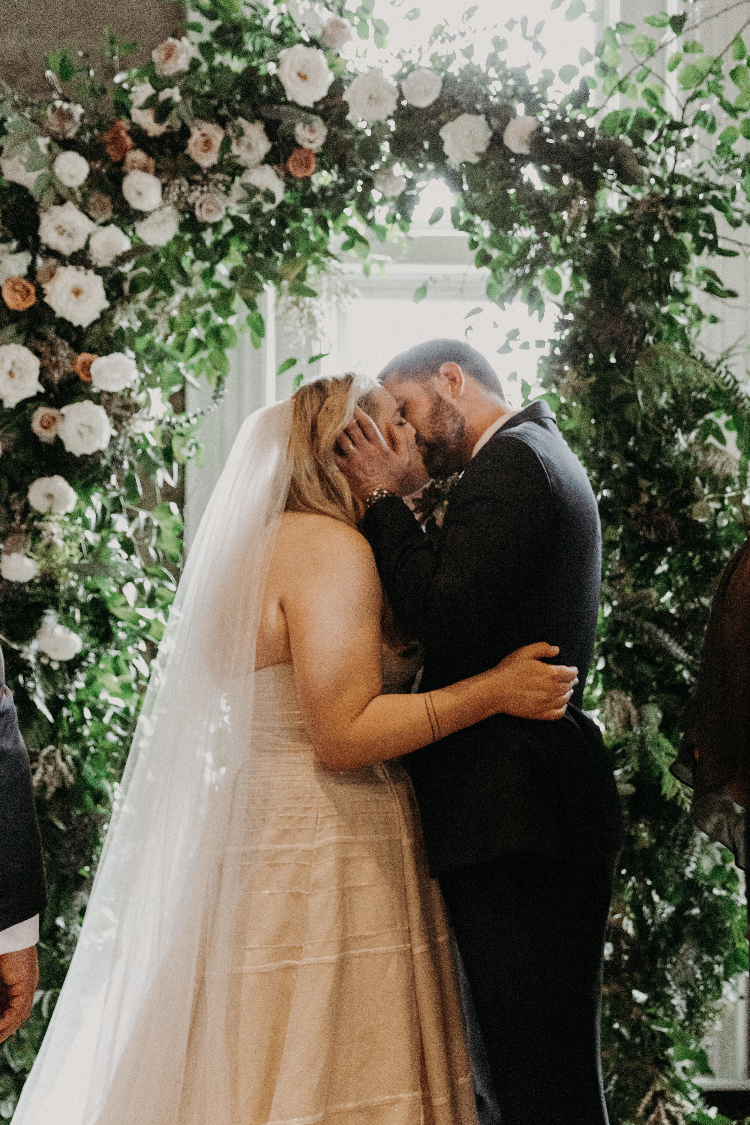 First kiss under a profusion of flowers  // Nashville Wedding Florist