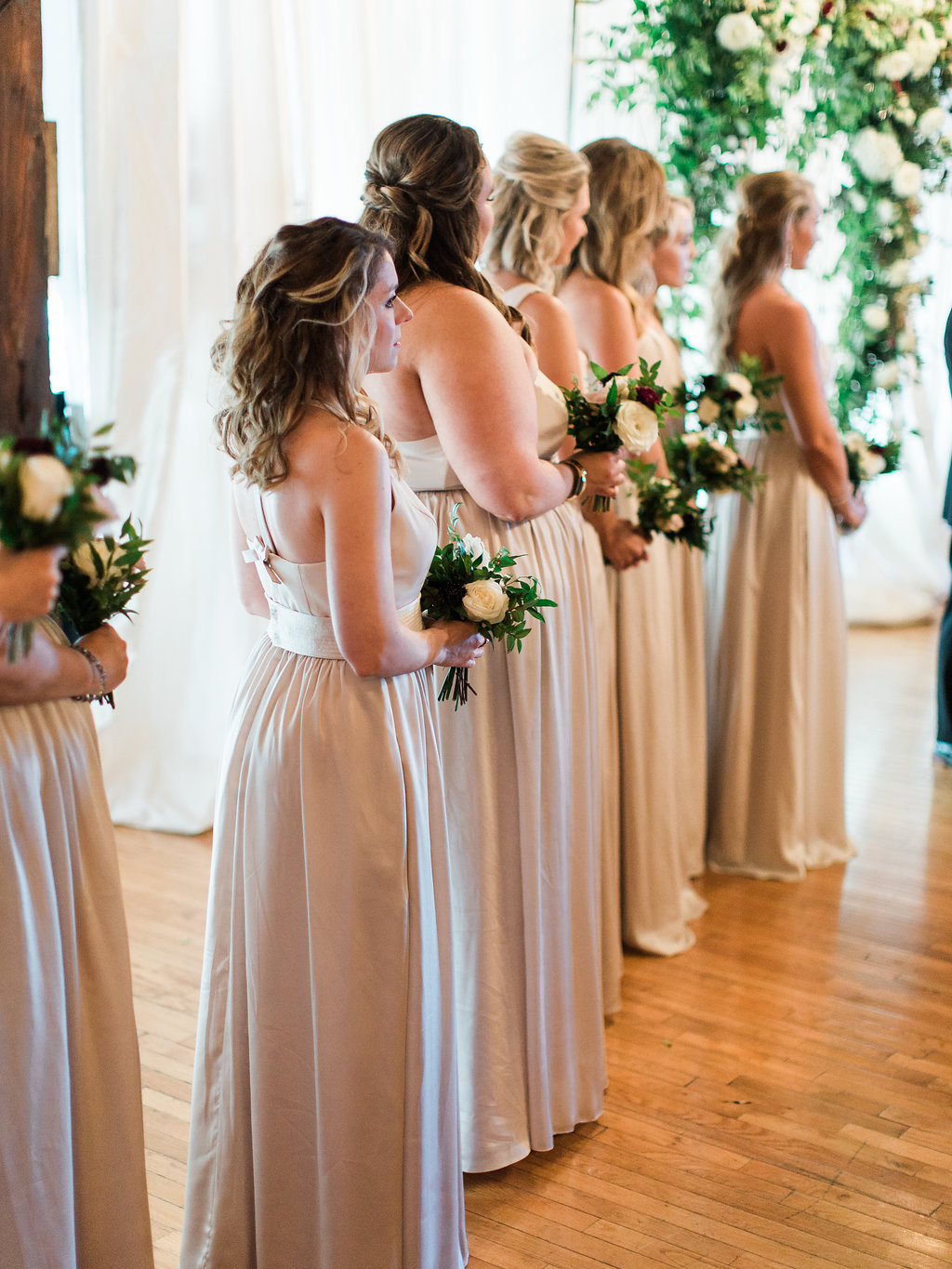 Lush wedding ceremony arch with natural greenery, blush and white flowers, and hints of marsala and burgundy // Nashville, TN Wedding Floral Design