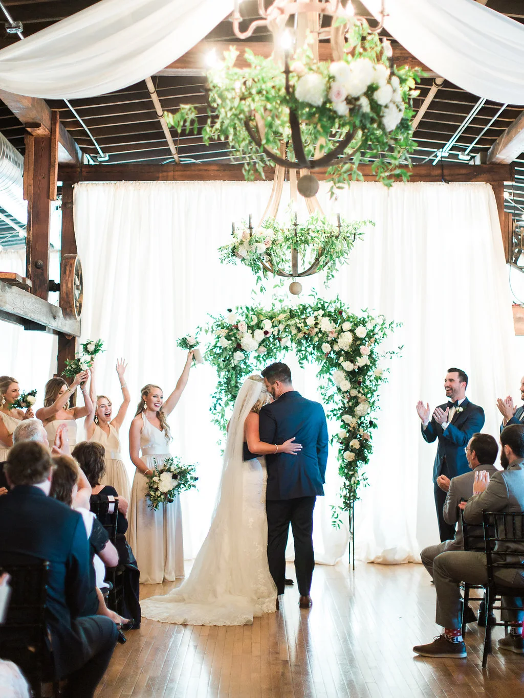 Lush wedding ceremony arch with natural greenery, blush and white flowers, and hints of marsala and burgundy // Nashville, TN Wedding Floral Design