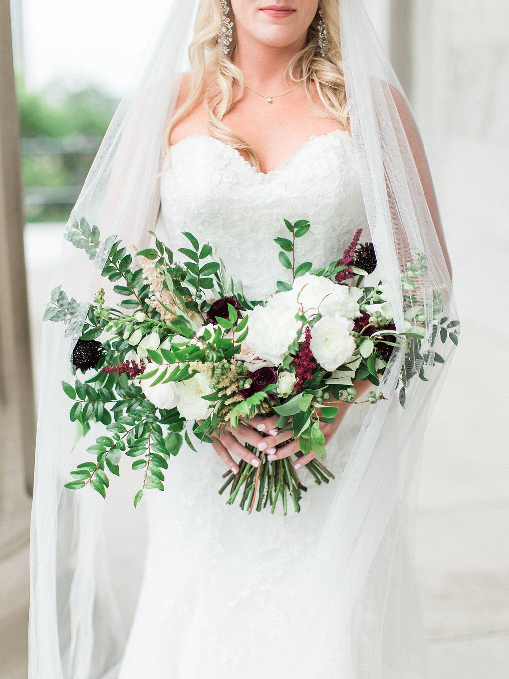 Loose, unstructured bridal bouquet with white, blush, neutral flowers and accents of burgundy // Nashville Wedding Floral Design